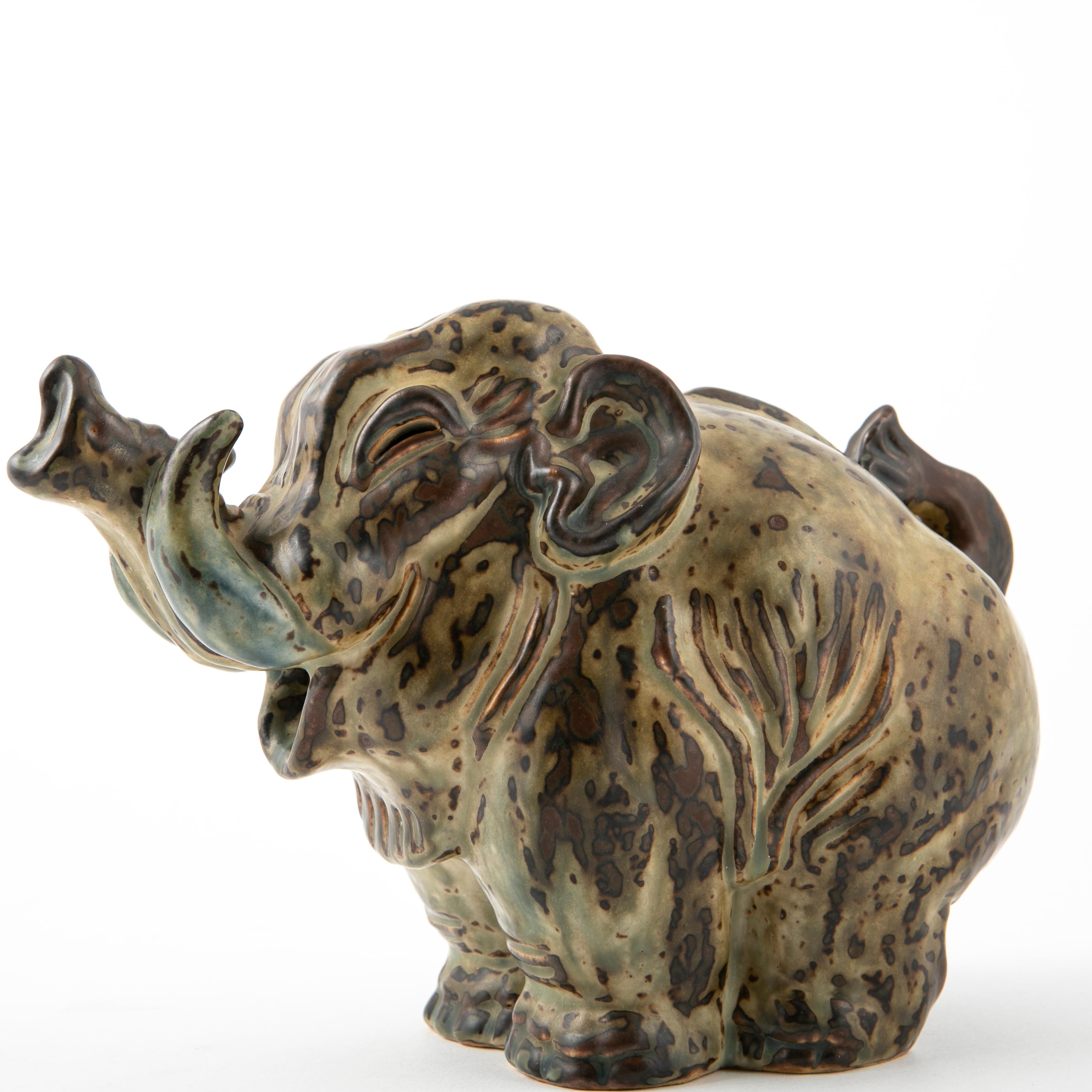 Sung glazed stoneware baby elephant by Knud Kyhn for Royal Copenhagen.
The sculpture is decorated with a light earthy Sung glaze with a touch of green.
Marked and signed KK to the base. No. 20138. Denmark 1950s.
Measures: H: 17 cm W: 23 cm. In