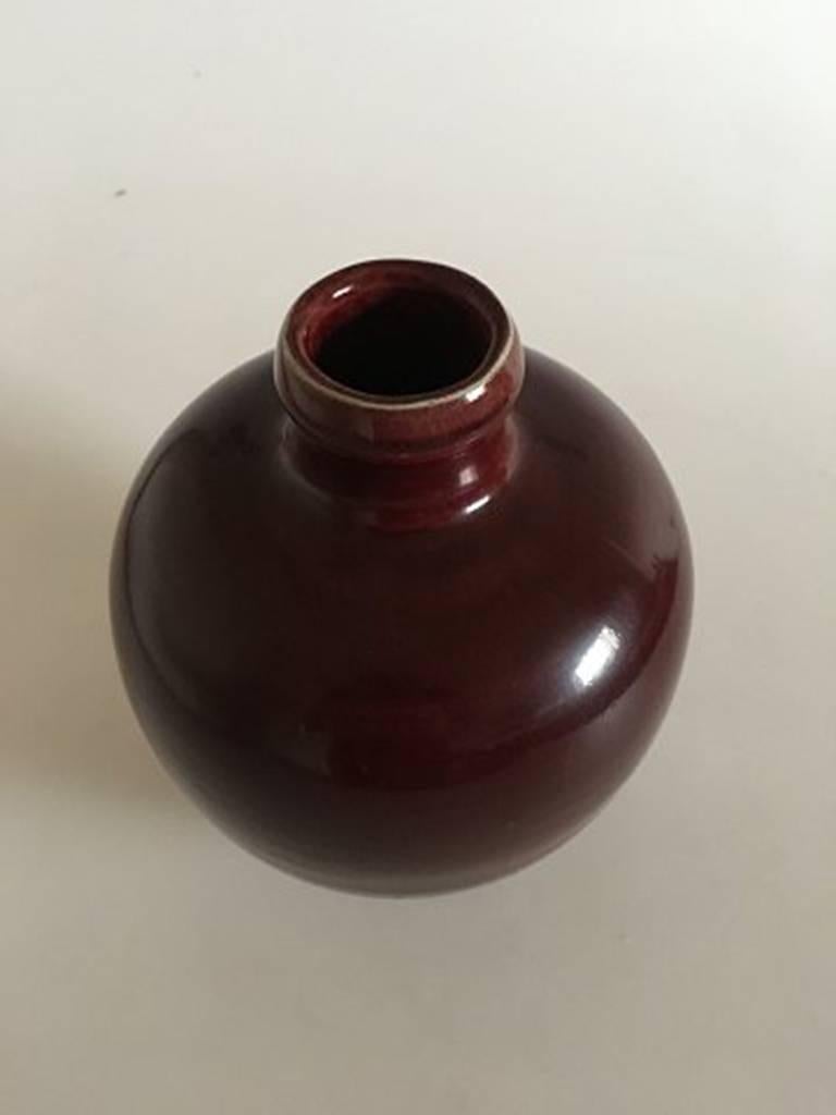 Royal Copenhagen stoneware vase in oxblood glaze Sang de Boeuf #97/43. Measures 19.2 cm and is in good condition.