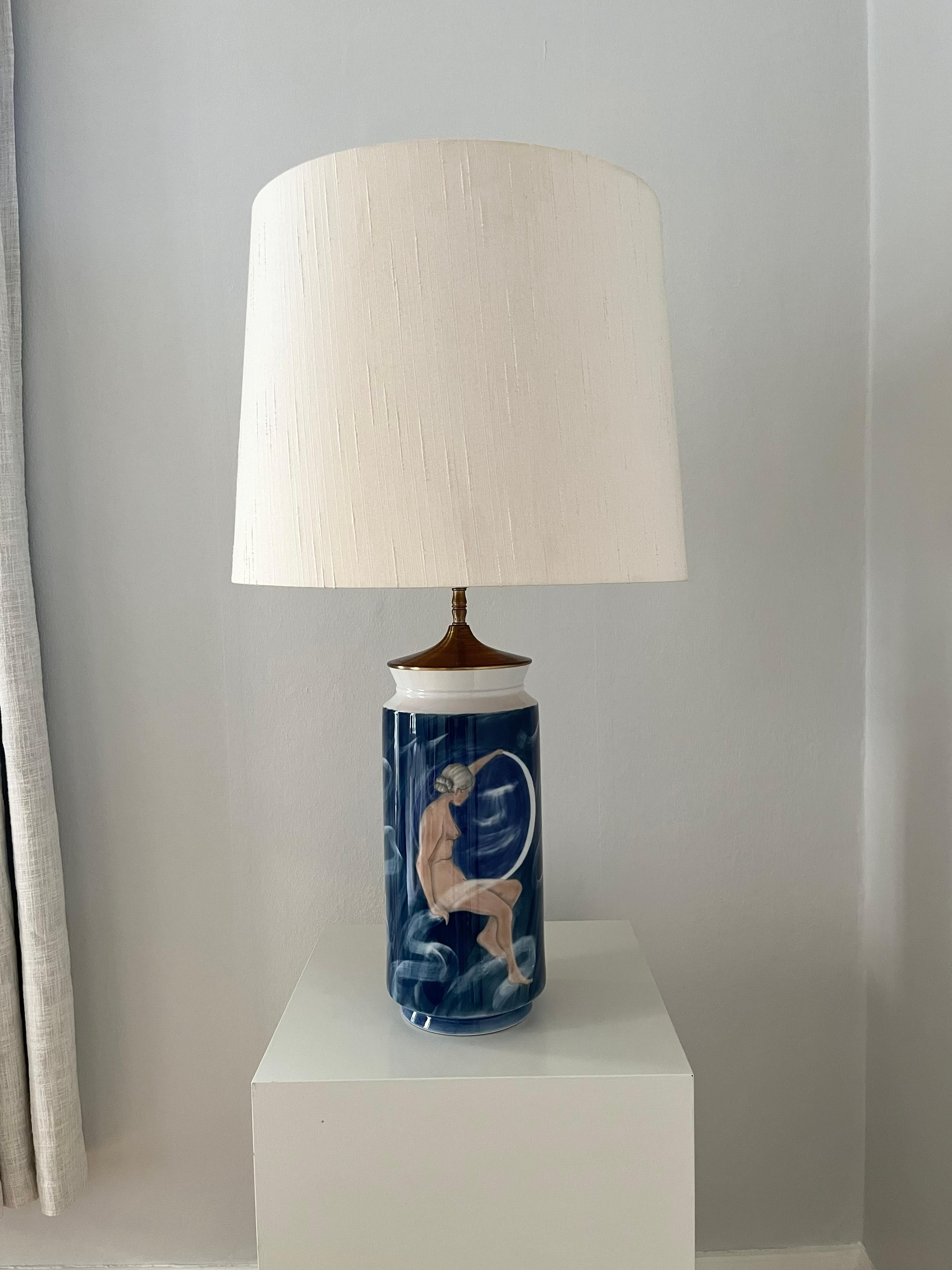 Tall and beautiful, this art deco style porcelain table lamp was designed in the 1920s by Danish artist and architect Arnold Krog (1856-1931) for Royal Copenhagen. 

Originally designed as a floor vase and mounted as a table lamp with a brass part.
