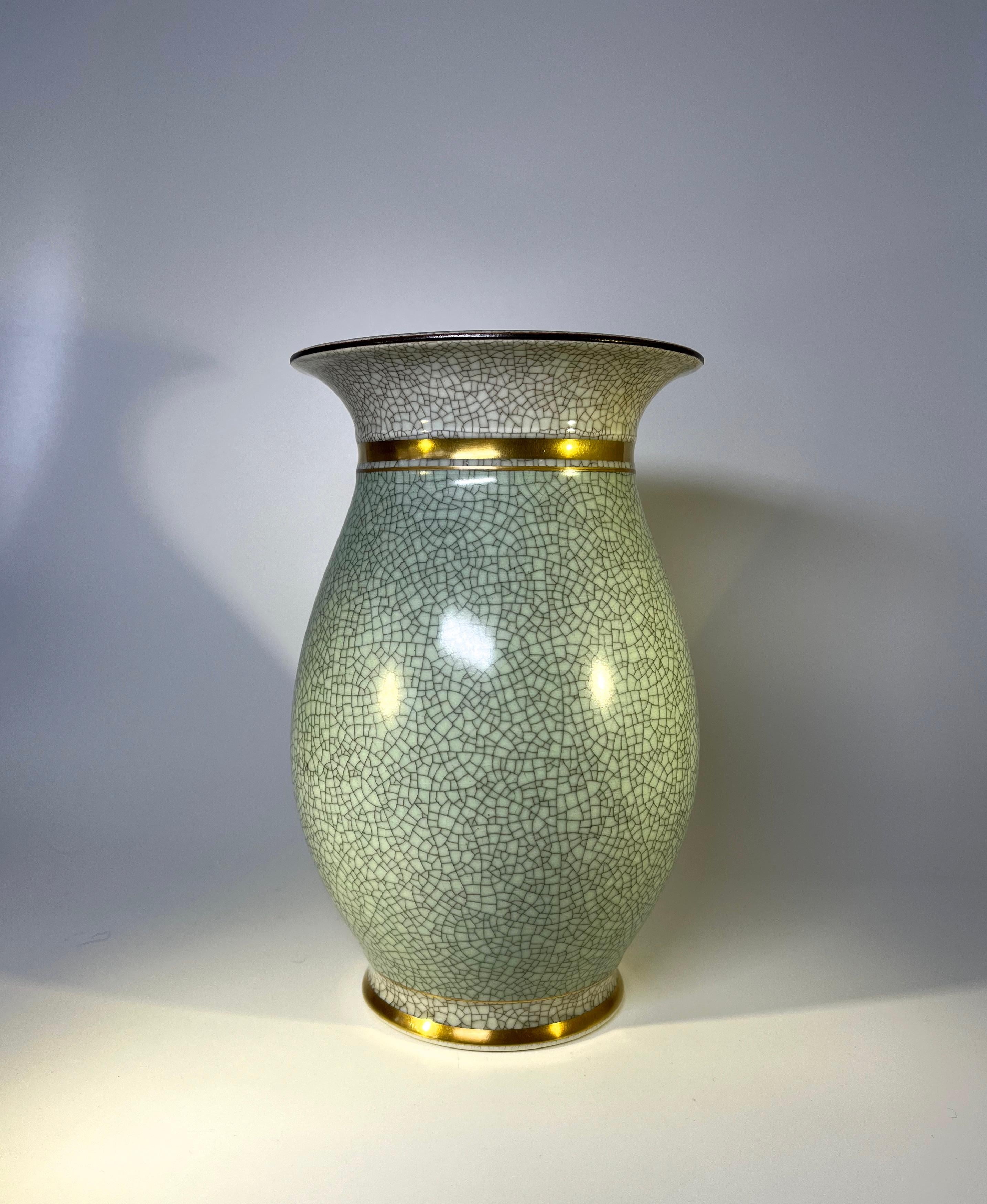 Generously sized royal copenhagen thorkild olsen porcelain baluster vase #2750
Classic sage green and pale grey crackle glaze, enhanced with gilded banding
circa 1953
Stamped and numbered 2750
Measures: Height 8.5 inch, diameter 5 inch
In very