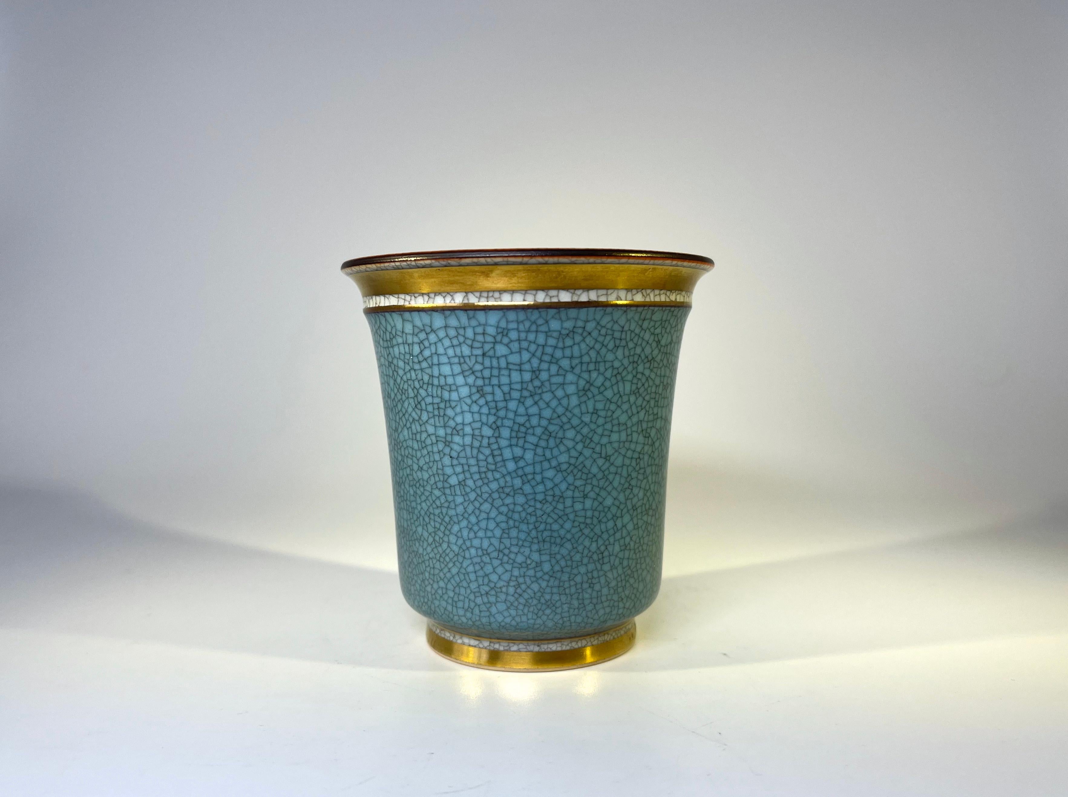 Thorkild Olsen for Royal Copenhagen, Denmark, porcelain crackle glaze tumbler pot
Turquoise crackle glaze with gilded bands. Pale grey crackle interior
Circa 1963
Stamped and numbered 3491
Height 3.5 inch, Diameter 3 inch
In very good condition.
