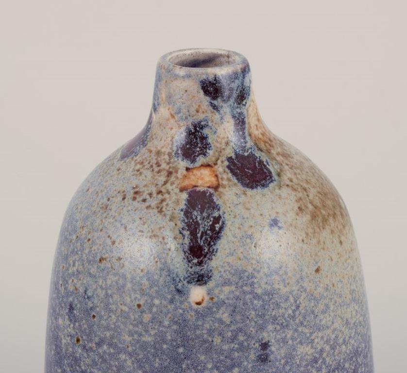 Royal Copenhagen. Vaso in ceramica unico nel suo genere. 
Smalto Test nei toni del viola. 
Contrassegnato da tre onde blu e 13.
Probabilmente negli anni '30.
Condizioni perfette.
Prima qualità di fabbrica.
Dimensioni: Altezza 13,0 cm. x Diametro 8,5
