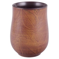Royal Copenhagen, vase in burnt red clay, decorated with foliage.
