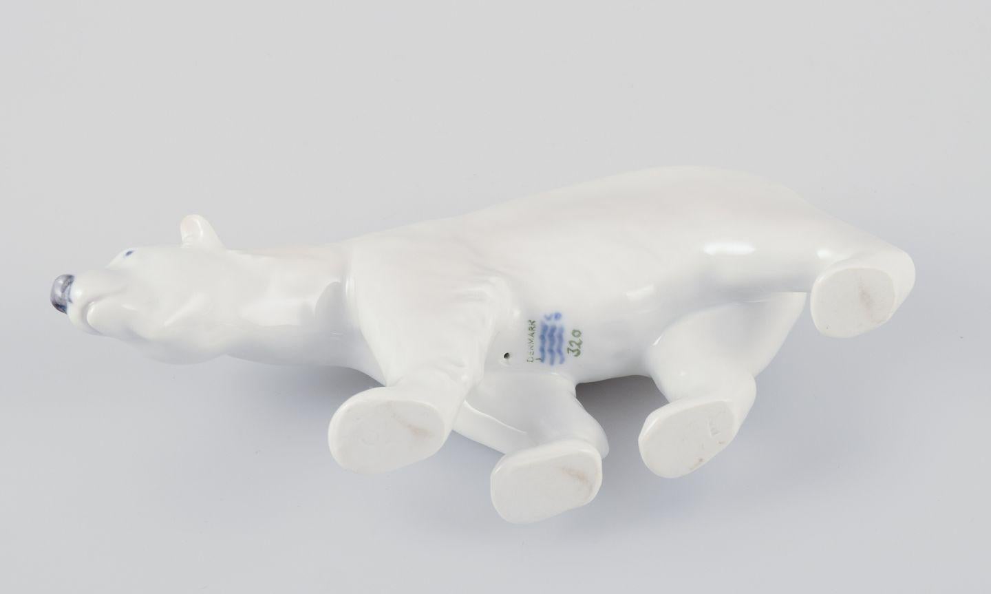 Glazed Royal Copenhagen, walking polar bear figurine in porcelain. Approx. 1930 For Sale