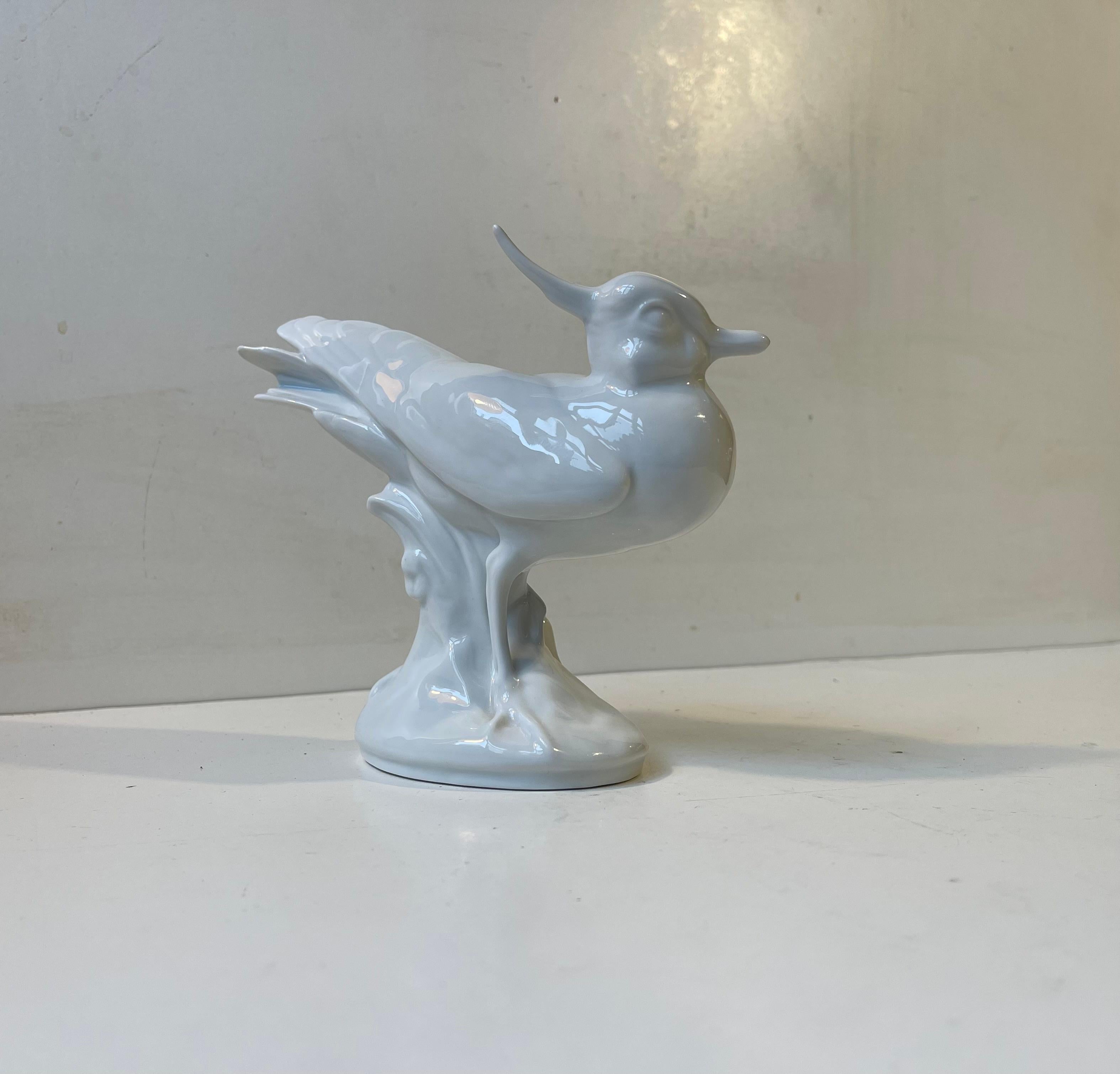 A stylish Vibe bird,Vanellus vanellus in latin. Relaunced in 2008 by Royal Copenhagen in Denmark in their 'white line'. A series in all white glazed porcelain animals designed by Knud Møller and Jeanne Grut. This one is a 1st grade and its by Knud