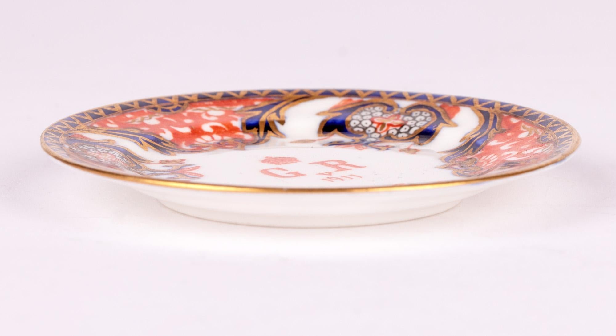 A very fine and scarce Royal Crown Derby miniature porcelain pin dish made to commemorate the Coronation of King George V dated 1911. The dish is very lightly made of small saucer shape with a raised rim and is hand decorated in the Imari pattern in