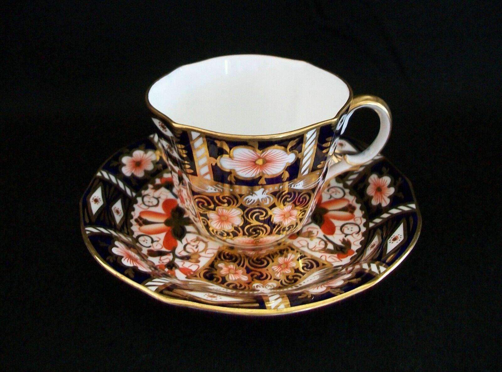 ROYAL CROWN DERBY - Imari Pattern Number 2451 - Antique bone china tea cup with fluted sides (circa 1912) and an antique saucer (circa 1916) - elaborate gilt decoration over blue and orange hand painted oriental pattern - each signed on the