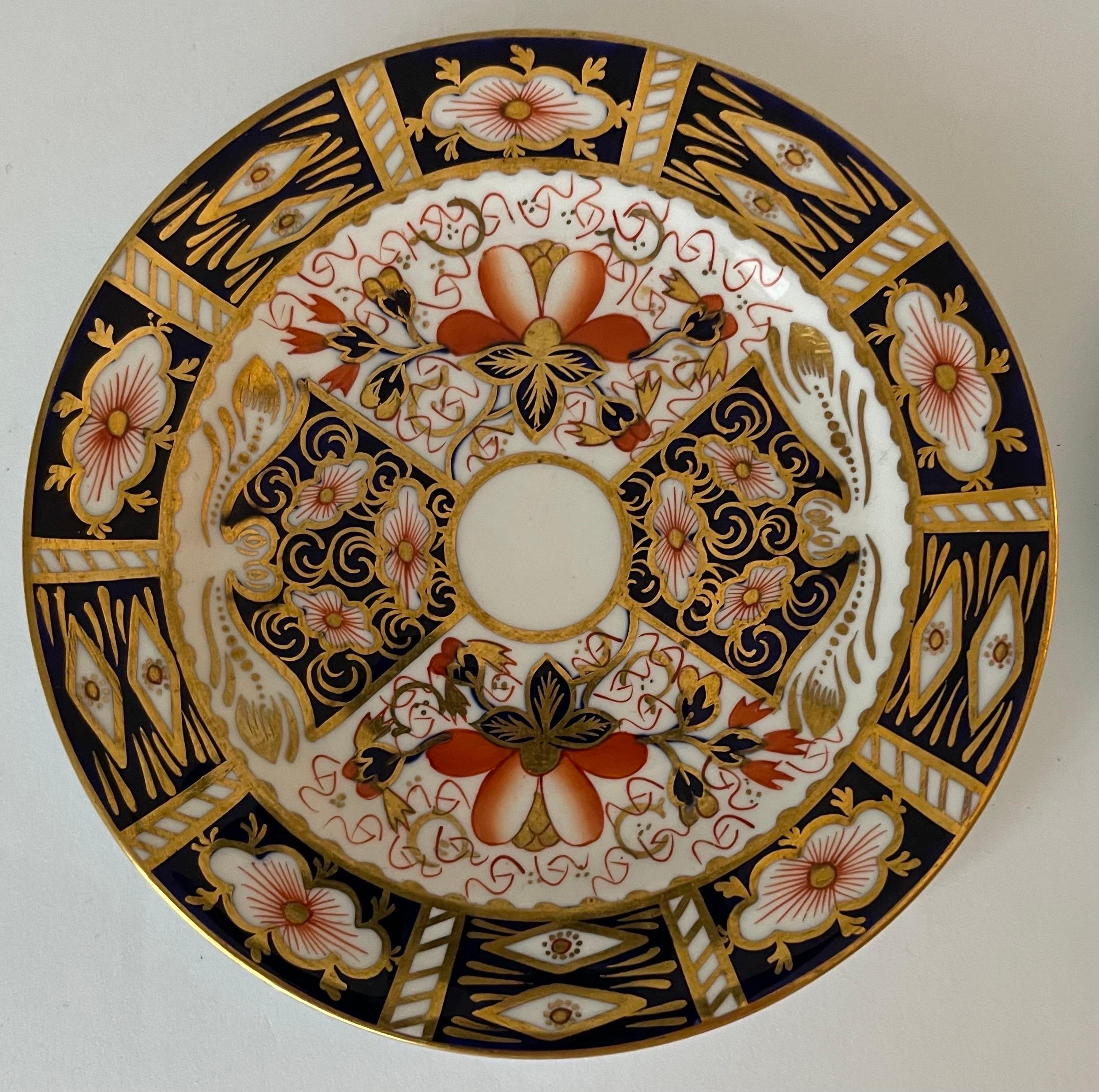 Set of two 1960s Royal Crown Derby Imari pattern small plates. Each plate varies slightly. Both plates have Royal Crown Derby brand stamp on the underside. 
