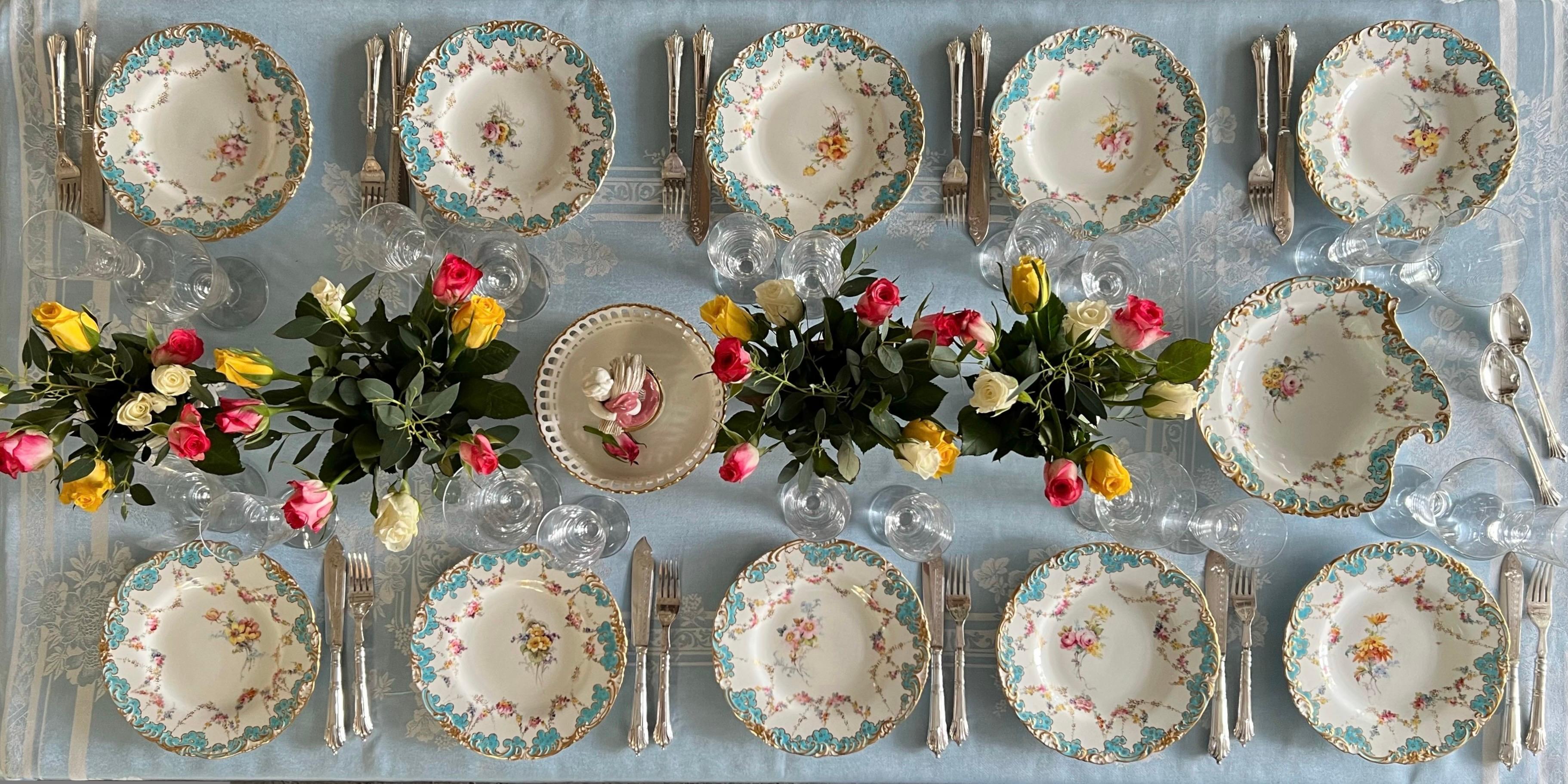This is a beautiful part dessert service made by Royal Crown Derby in 1916. The service consists of one serving dish and ten plates, and is decorated with beautiful scalloped rims in turquoise and gilt, delicate flower garlands and a very find