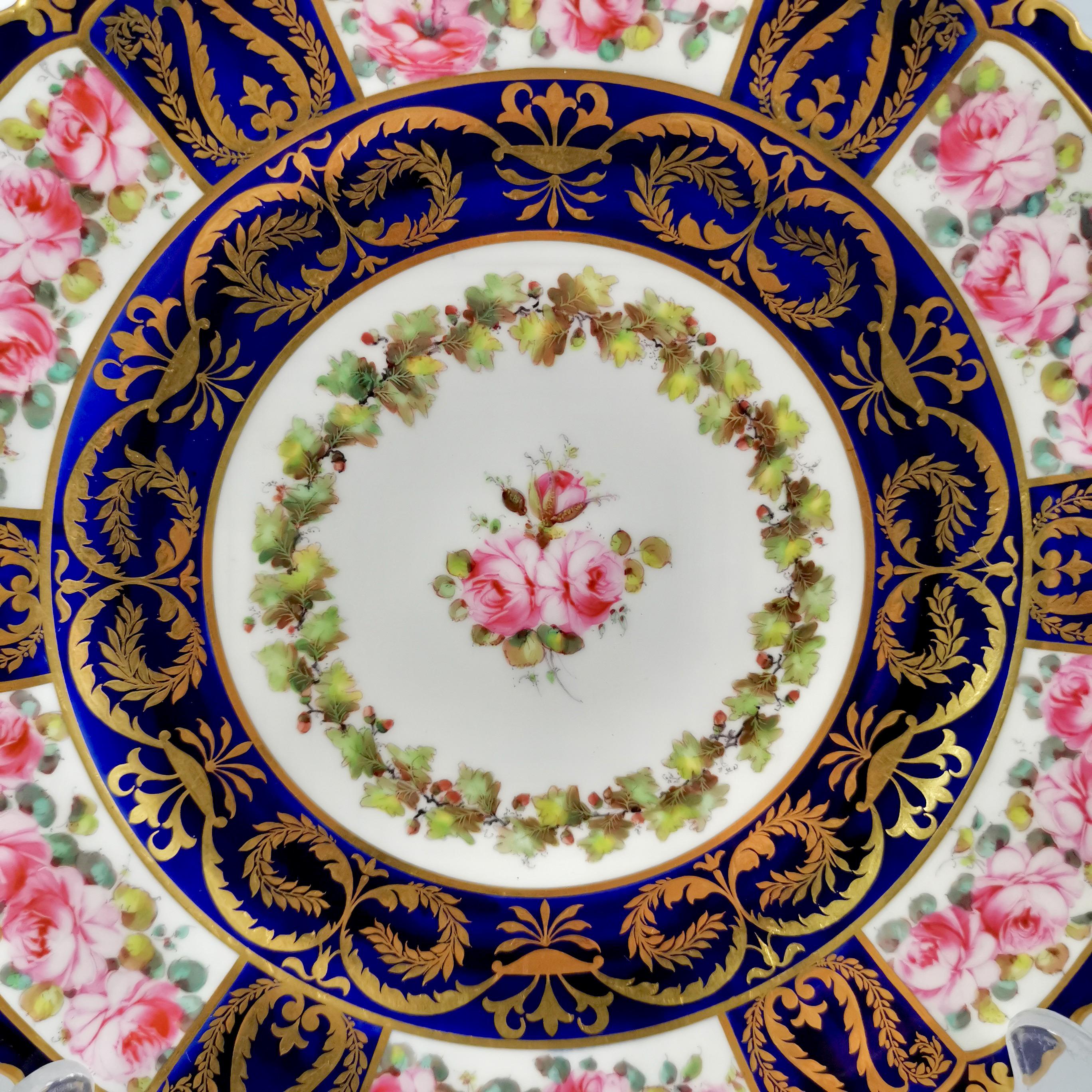 This is a stunning cabinet plate made by Royal Crown Derby in 1899. The plate has a deep cobalt or mazarine blue ground with rich gilt decorations and stunning roses painted by the celebrated porcelain artist Albert Gregory.
 
The Derby Porcelain