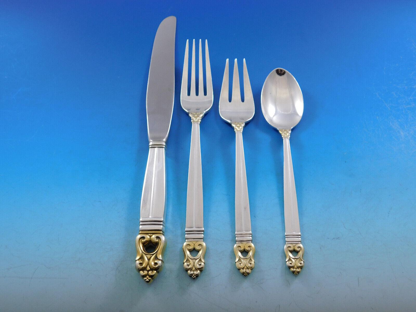 Royal Danish Gold Accent by International Sterling Silver flatware set - 61 pieces. This set has a gold accents on the tip and the base of the scrolling handle design and includes:

12 Knives, 9