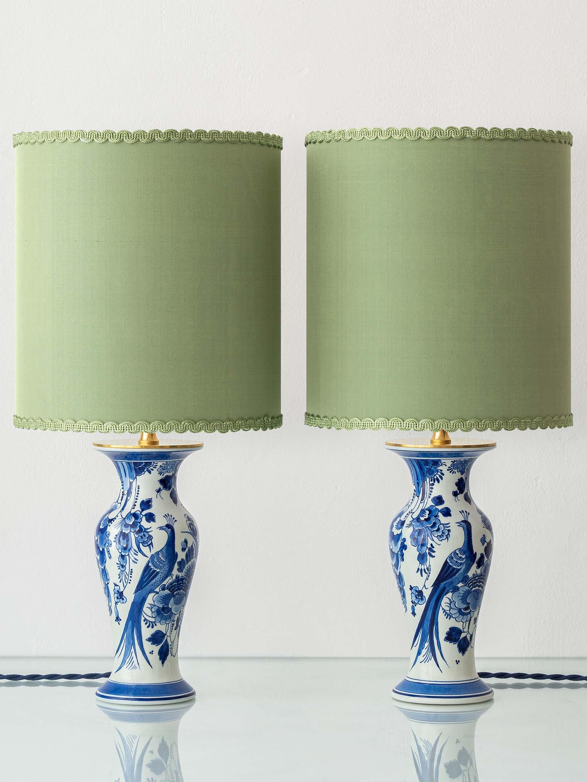 Exquisitely handcrafted by Amitābha Studio in Amsterdam from a pair of vintage Royal Delft Blue vases—hand-painted in 1978 and 1979 by master artisans—this one-of-a-kind duo of table lamps is a celebration of timeless Dutch artistry. Each lamp pairs