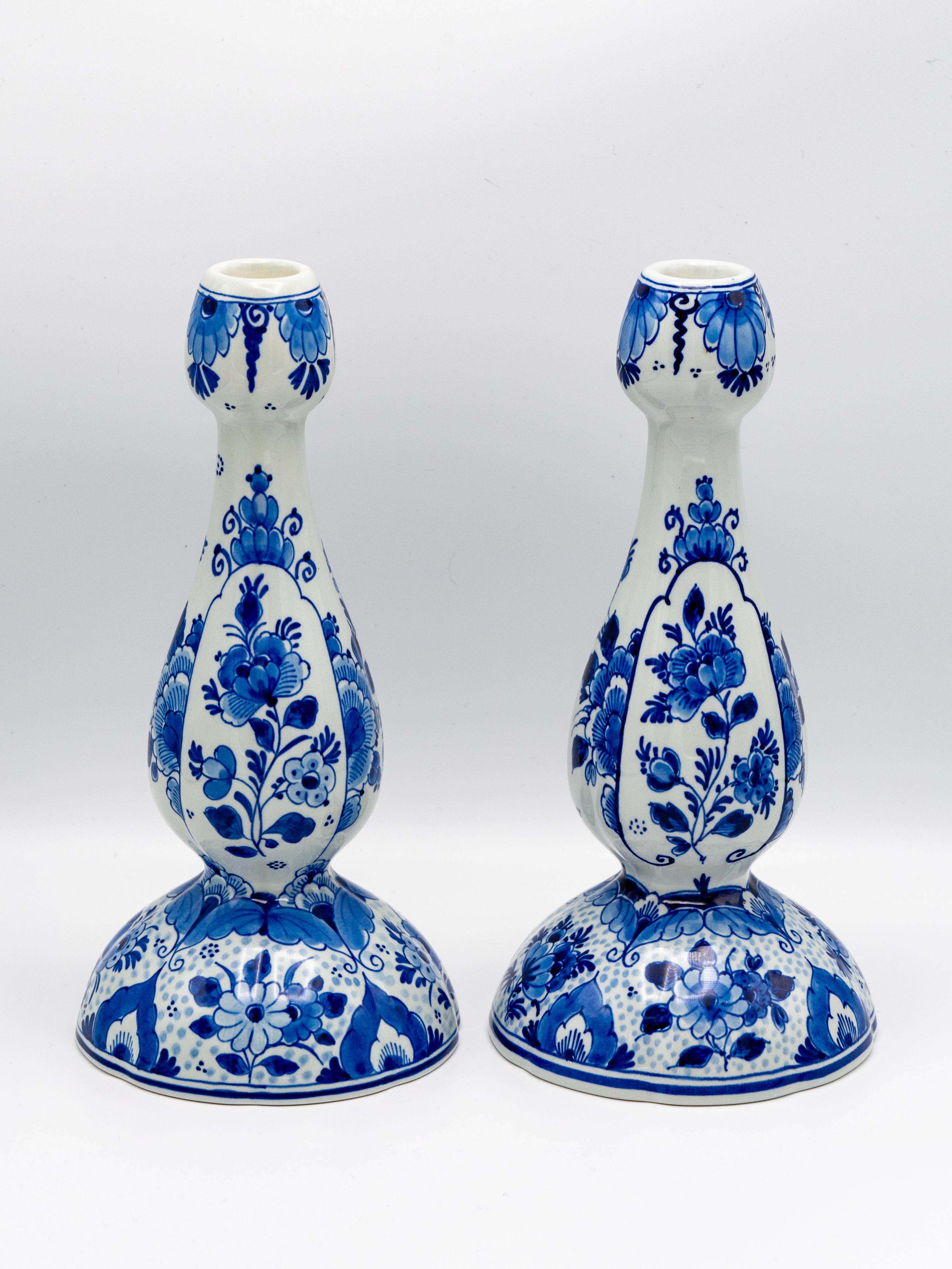 This elegant pair of tulip-shaped candlesticks was handcrafted by Royal Delft (De Porceleyne Fles), the oldest surviving Delftware factory, established in 1653. Known for its exquisite hand-painted Delft Blue ceramics, Royal Delft continues to