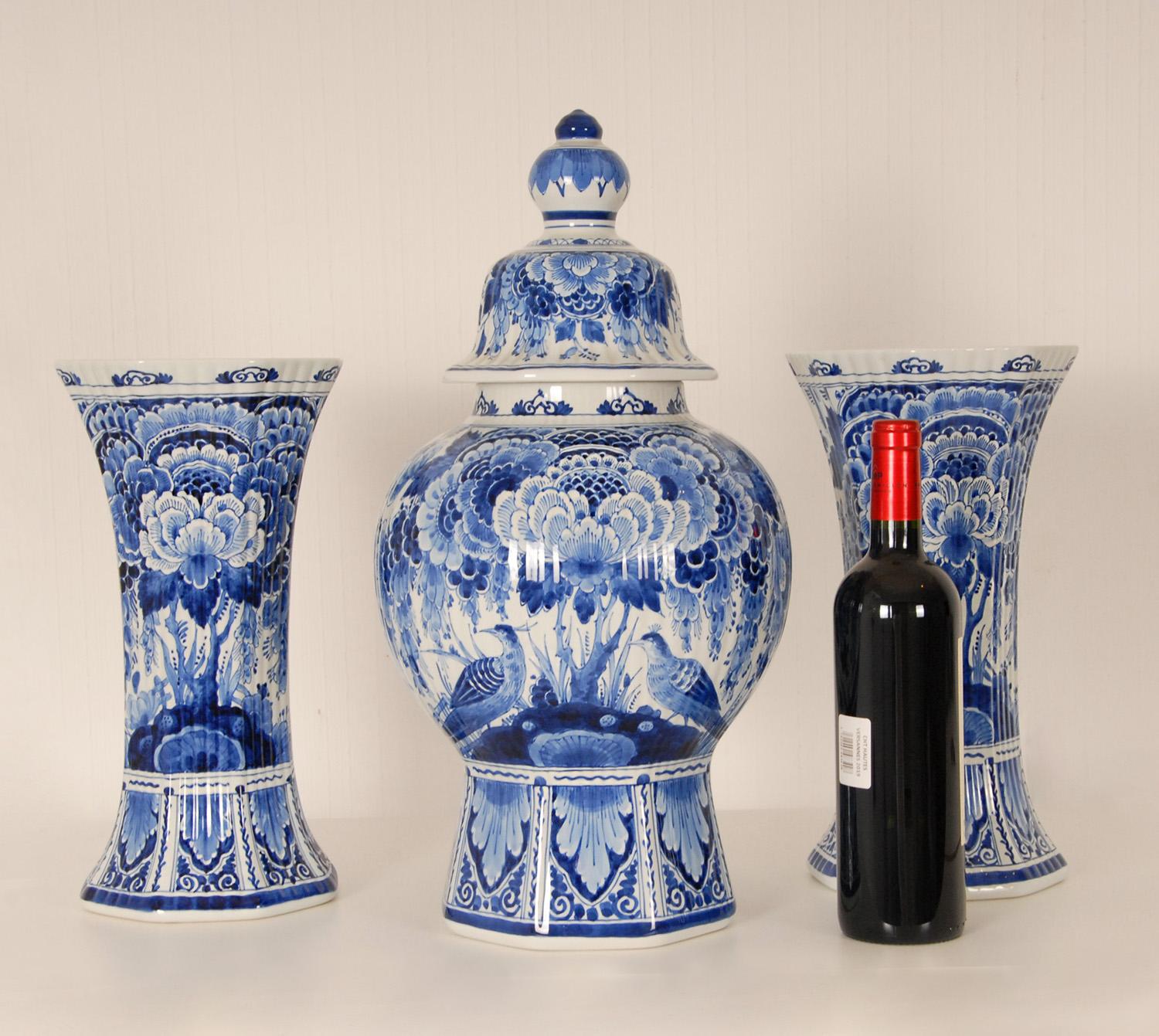 A 3 pieces garniture of Dutch Delftware Royal Delft vases - Urns.
Tall decorative covered baluster vases on an octagonal foot with 2 matching beaker vases
The vases are hand crafted and hand painted in enchanting blue colors, blue camaieu.
Floral