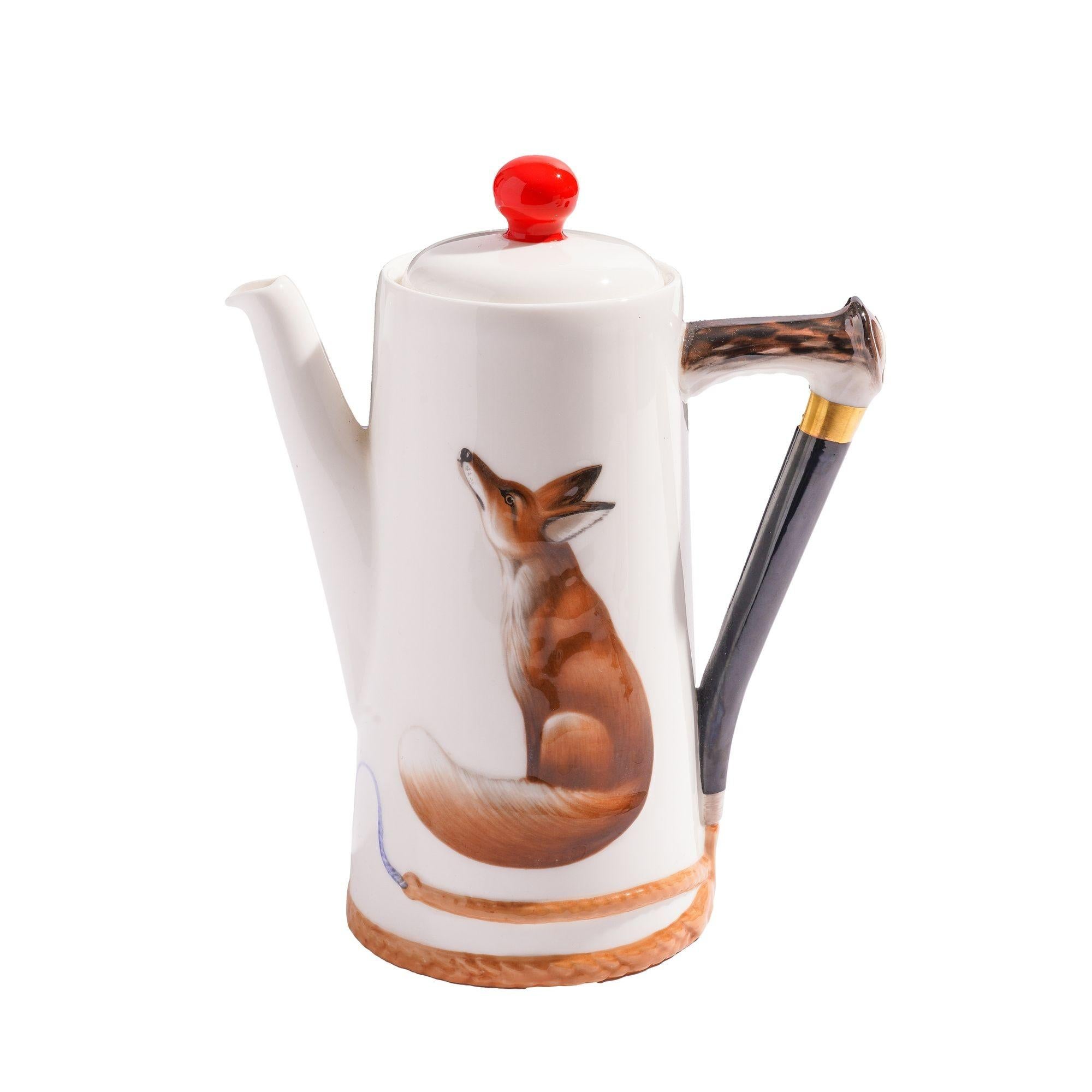 Chocolate service consisting of tall light house chocolate pot, creamer, and open sugar container. Each piece bears the figure of a fox and is fitted with handles in the form of a riding crop handle. The pot has a lid with a orange red ball