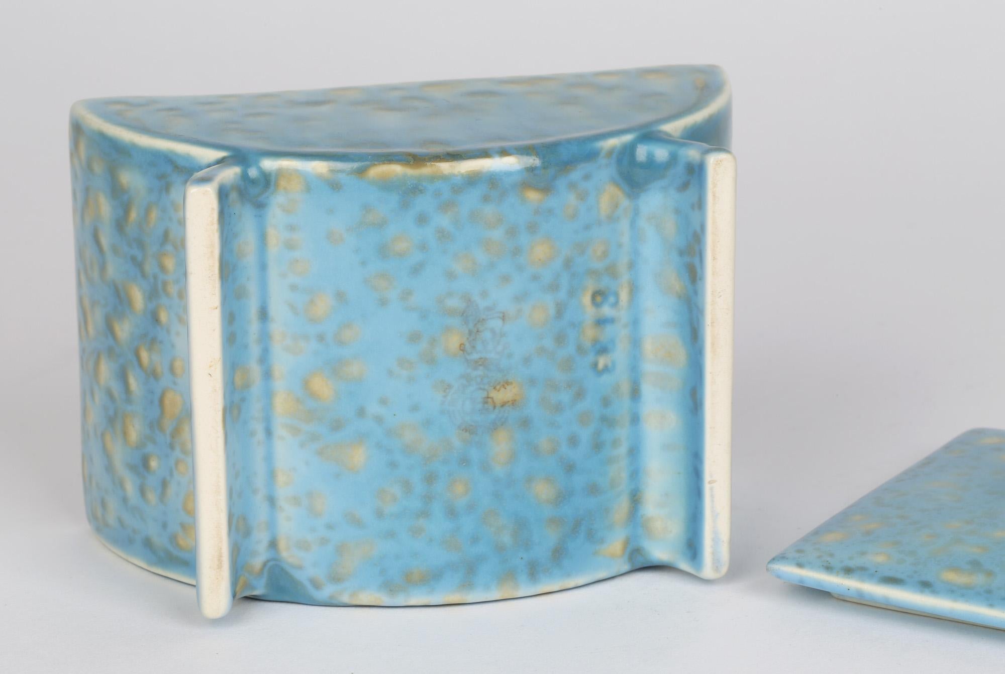 Unusual Royal Doulton Art Deco pottery playing card holder in mottled blue and yellow glazes dating from around 1925. The card holder is raised on two rounded legs with a rounded body and with a flat fitted cover with a handle molded with the