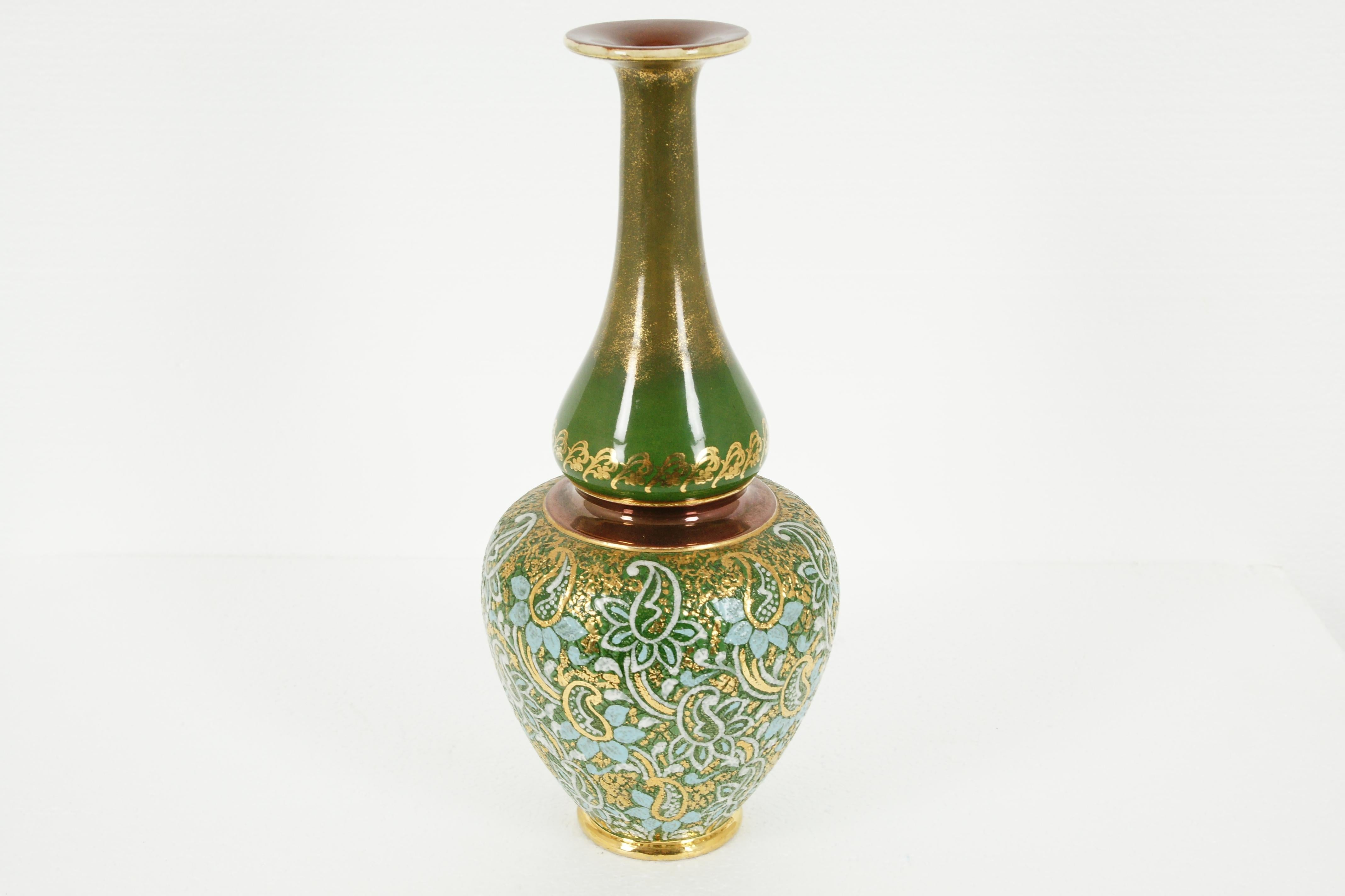 Royal Doulton glazed stoneware slater mantle vase, England, B1992

England
Glazed stoneware vase, Persian bottle shape
Overlaid with hand painted flowers
With gilt trim, green neck
Stamped underside: Doulton Slater Lambeth 24 F5608 
No chips,