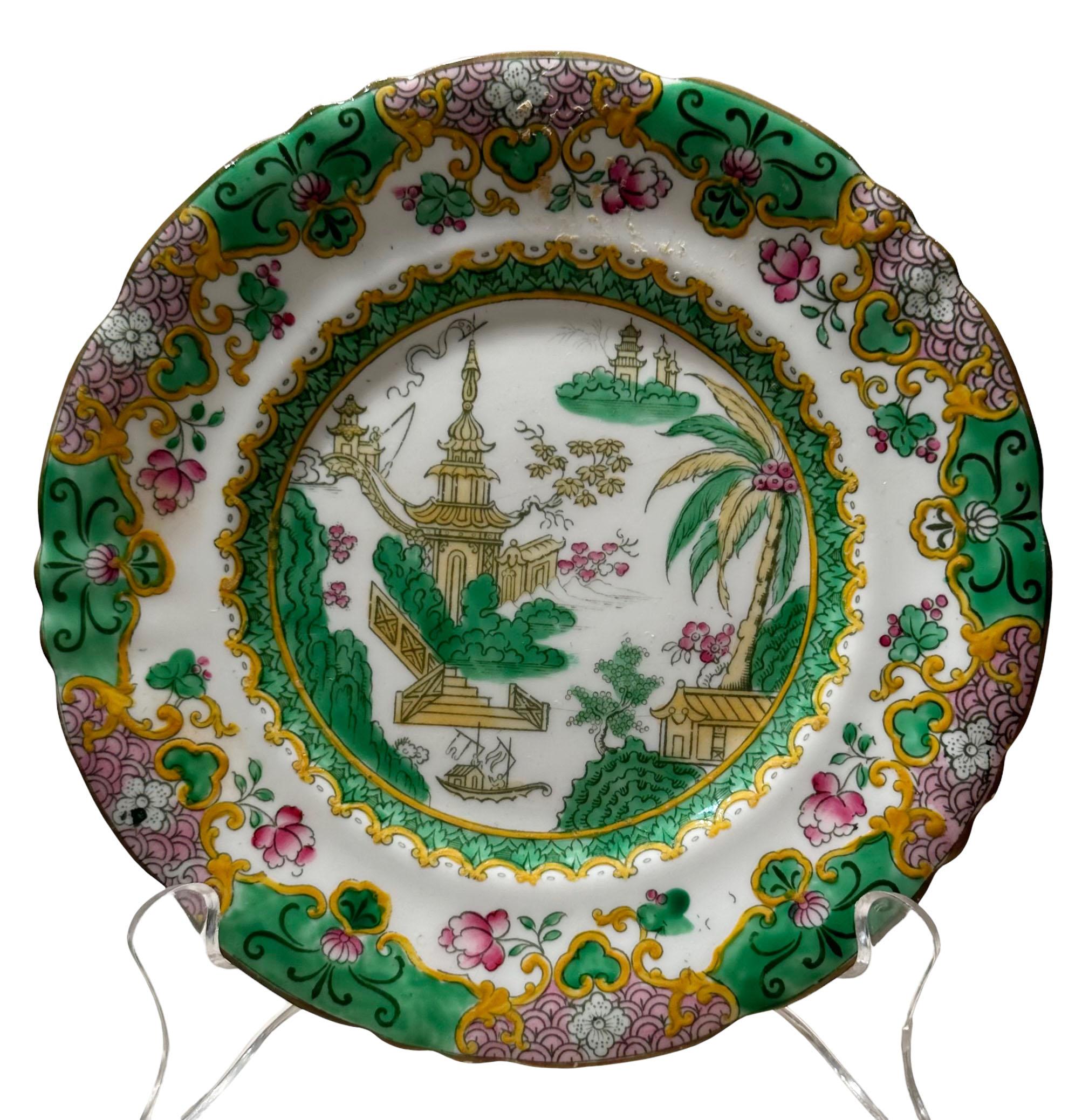 An antique pair of Royal Doulton plates depicting an oriental garden scene. Circa 1890s, England.