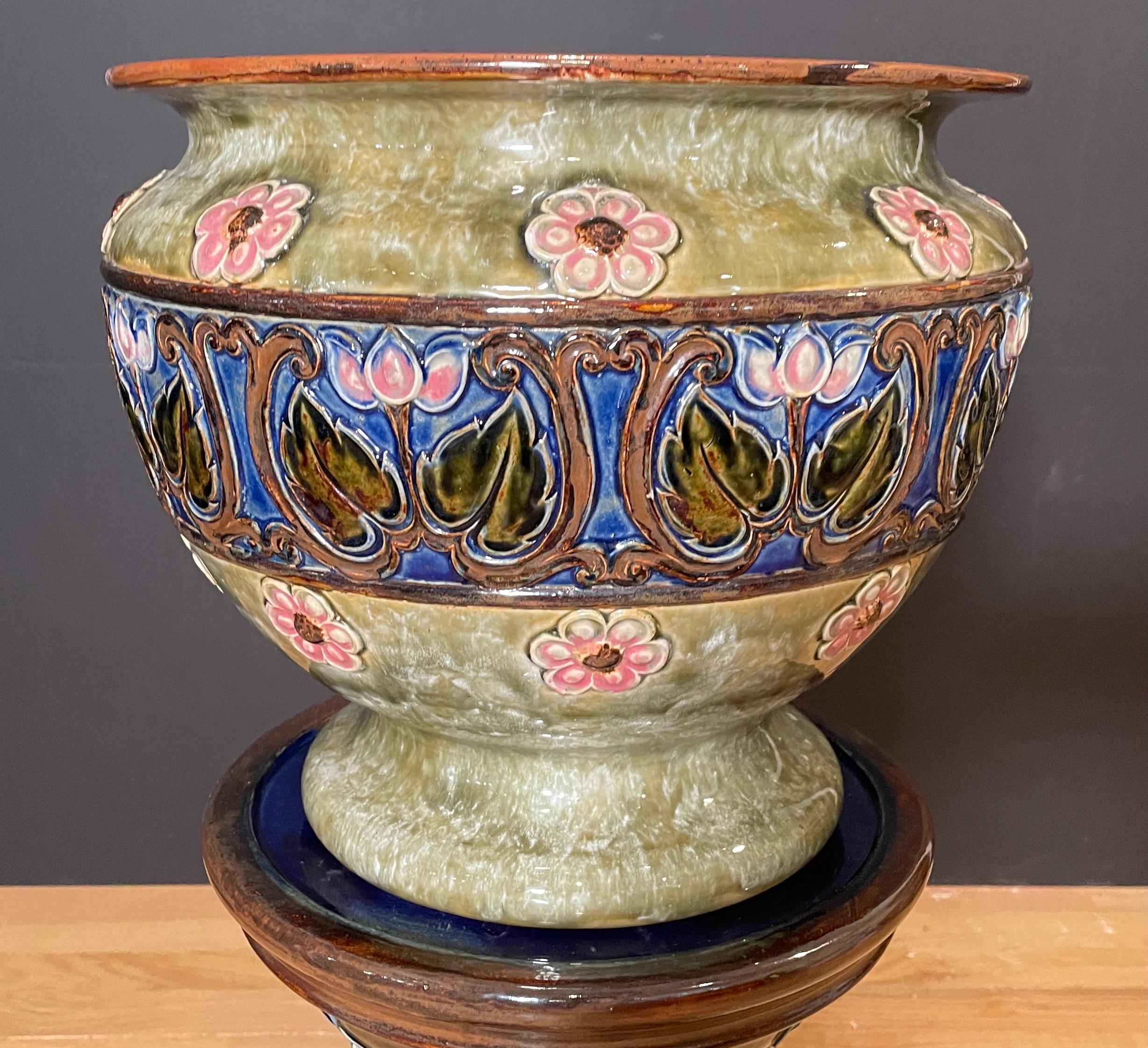 Art Deco Royal Doulton fully marked jardinière on stand. Dark cobalt blue with green and brown ground and pink flowers. Planter on stand from the early 20th century.
Planter opening 11.5