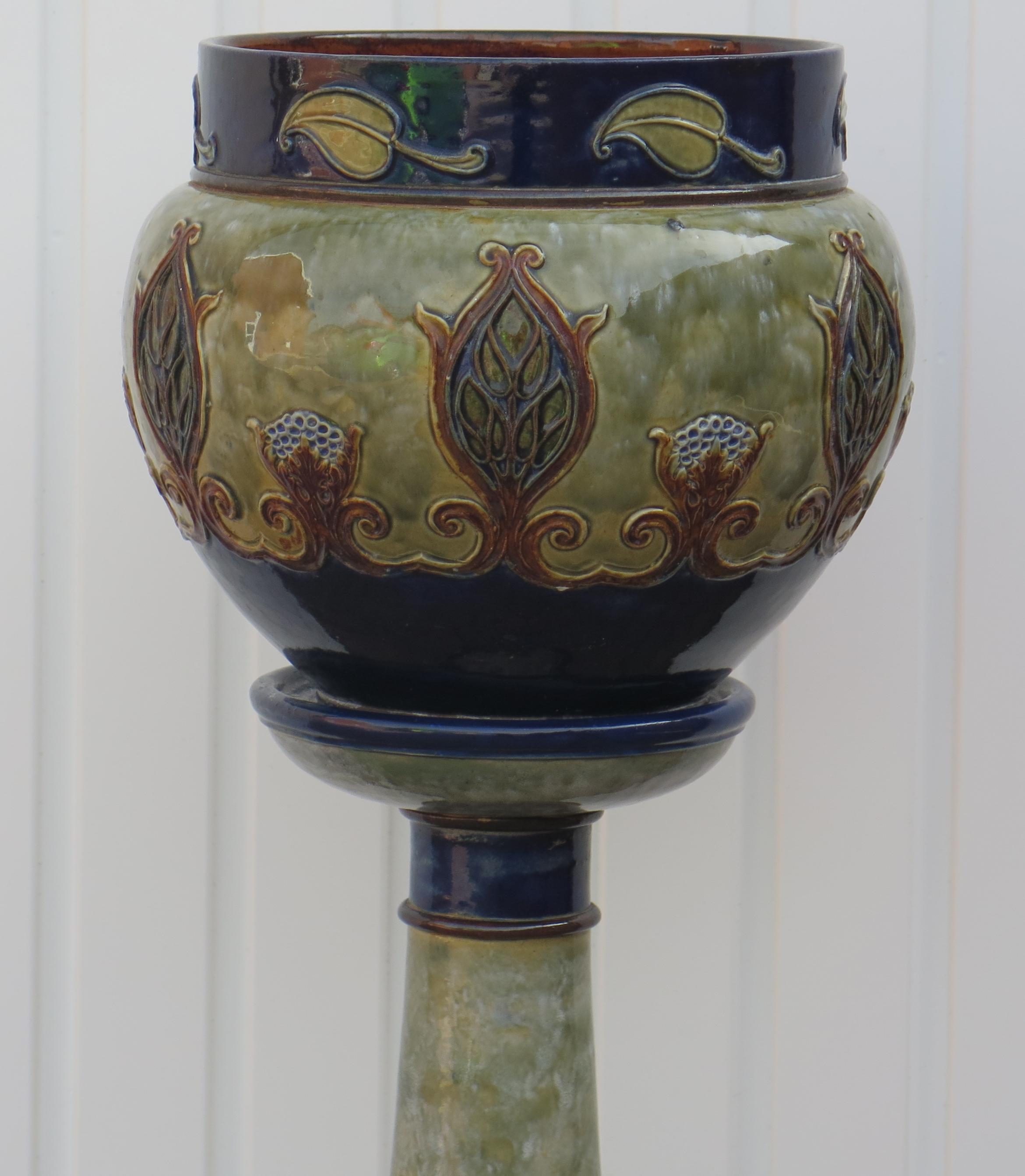 This is a very good large Jardiniere on Stand made by Doulton Lambeth, dating to Circa 1925.

This is a large, impressive and very decorative floor standing piece. 

The decoration has an applied moulded floral decoration all in the Art Nouveau