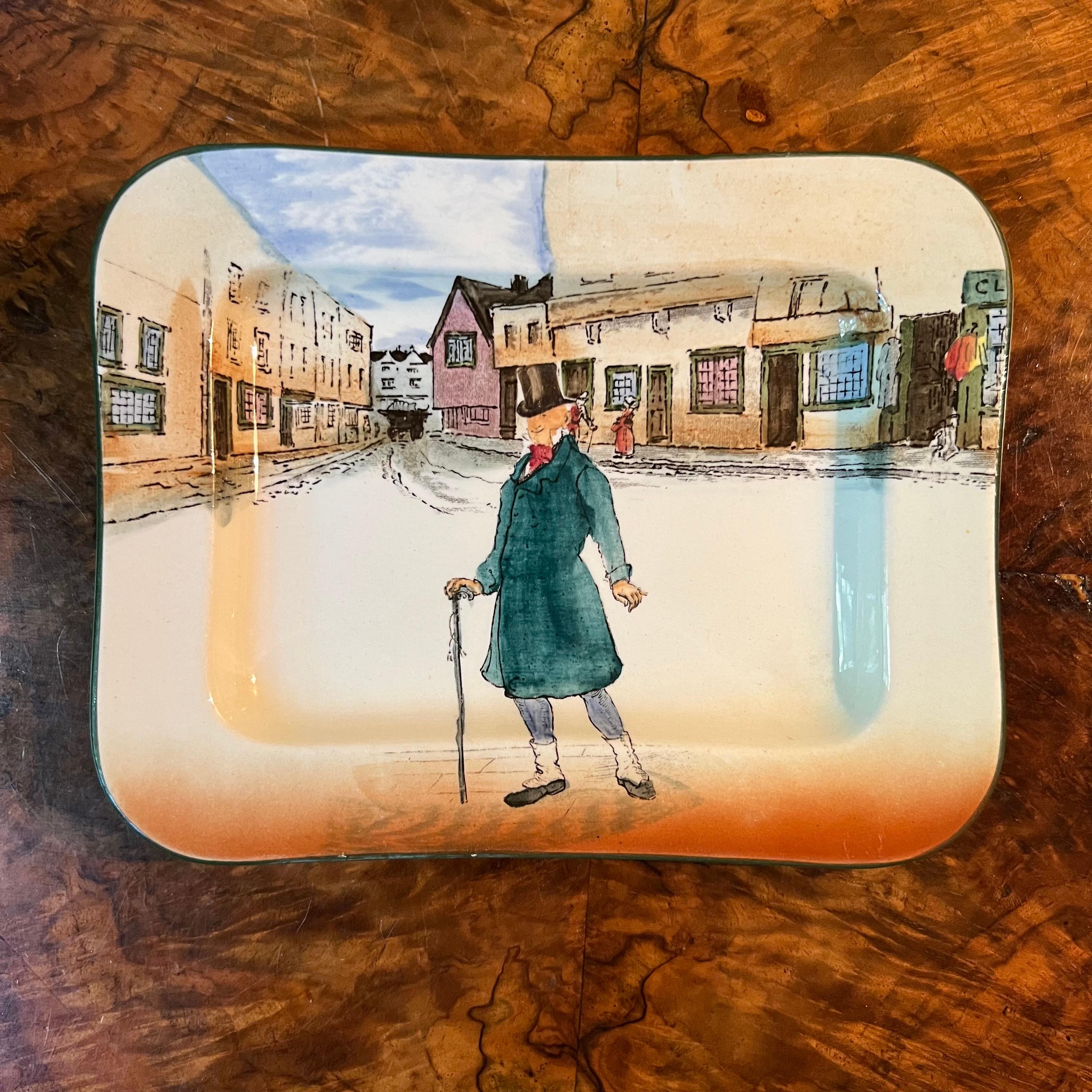 Rectangle plate like dish with a man Mr Micawber, slight ware to print, stamped Royal Doulton Mr Micawber 

Material: Porcelain 

Measurements: 2cm high, 20cm length, 15.5cm width 

Postage via Australia Post with tracking available
