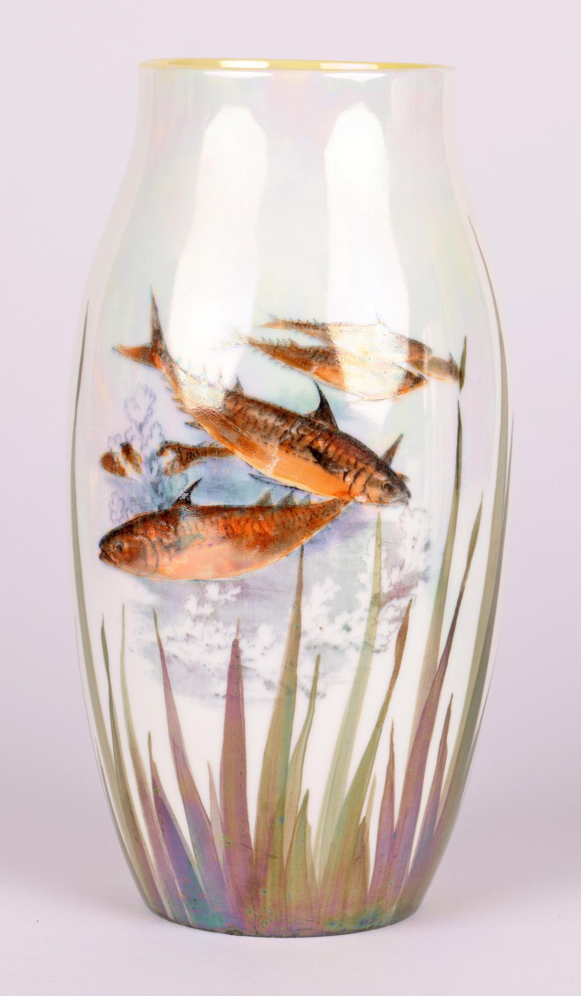 A Royal Doulton Art Deco lustre glazed pair art pottery vases decorated with fish dating from around 1920. The vases are made in porcelain and of tall round bulbous shape the bodies decorated with gold colored fish amidst pond weed. Decorated in