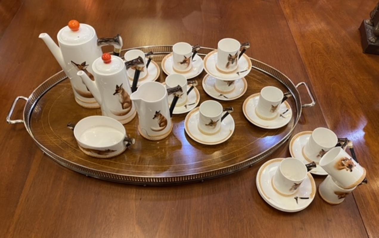 Complete porcelain coffee service set by Royal Doulton includes coffee pot, sugar bowl, creamer, and 12 demitasse cups and saucers. Hand painted porcelain with foxes. Created by Royal Doulton Reynard. Set includes coffee pot, sugar bowl, creamer and