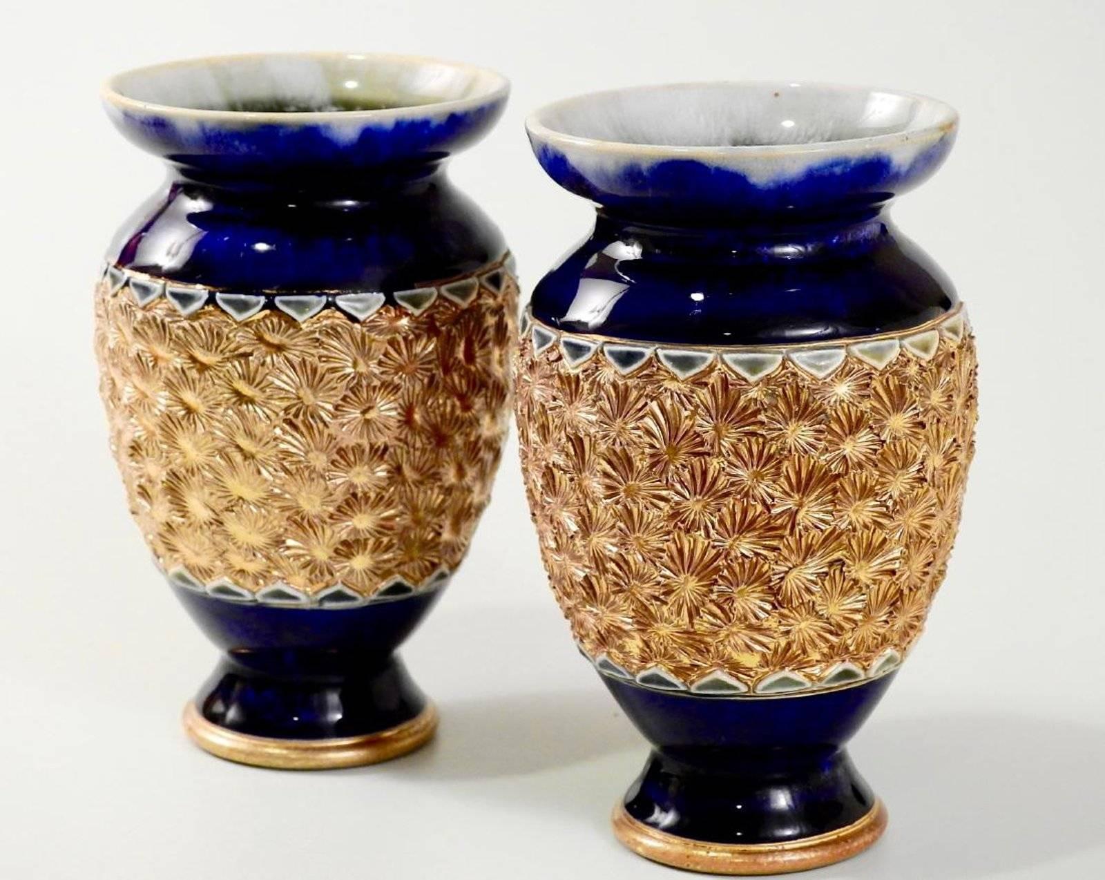 Lot of Royal Doulton including the following items:

Royal Doulton cobalt gold starburst encrusted vase pair, early 20th century aesthetic pottery vases
Approximately 5 1/16 inches tall. Perfect vintage condition.
Antique Doulton Lambeth