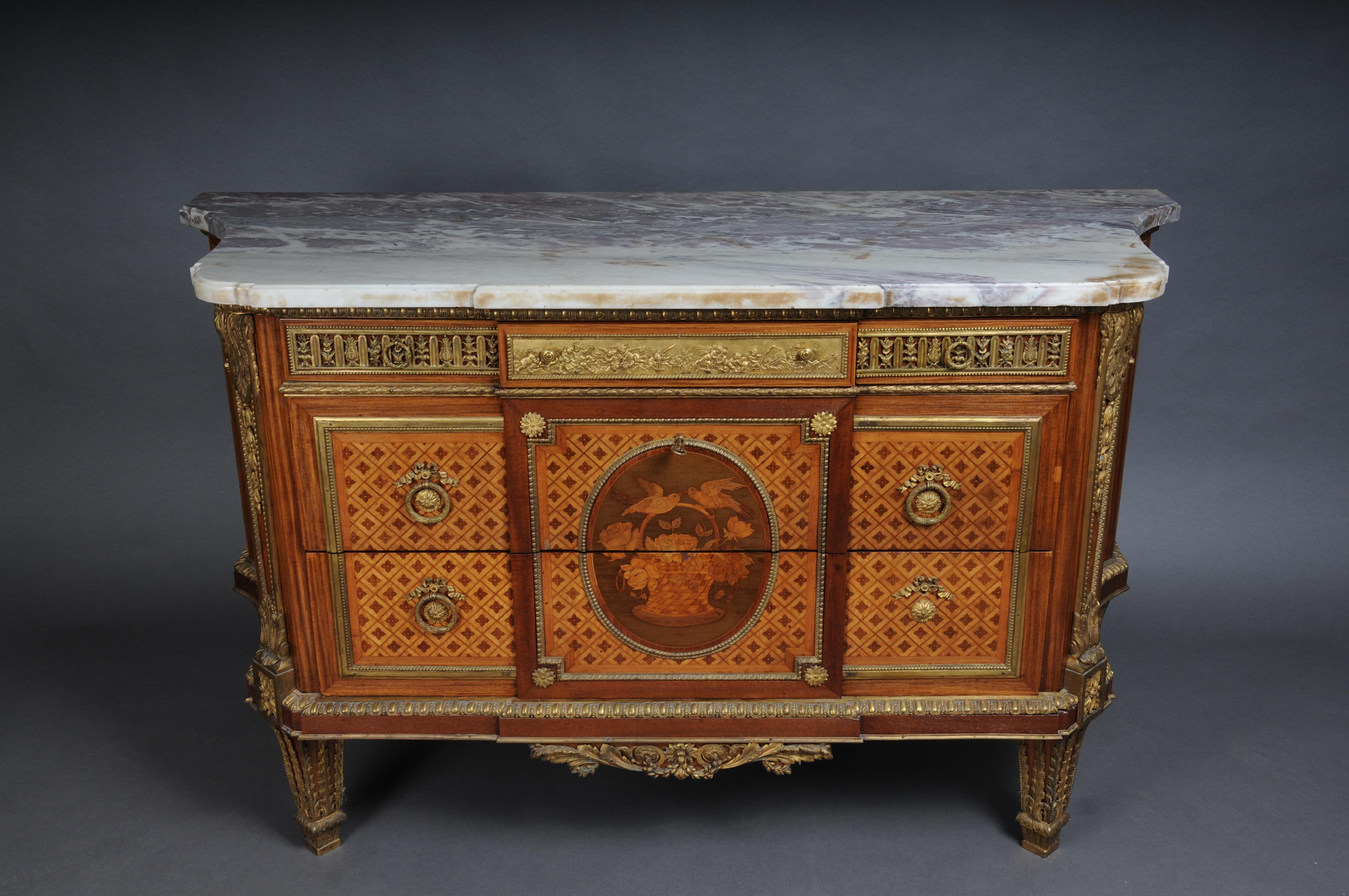 Royal antique pomp chest of drawers after J. Henri Riesener, Paris from 1880, gilded bronze

Various precious woods, veneered on a solid oak body. In the center marquetry in the form of stylized flowers and a pair of birds on a flower basket.