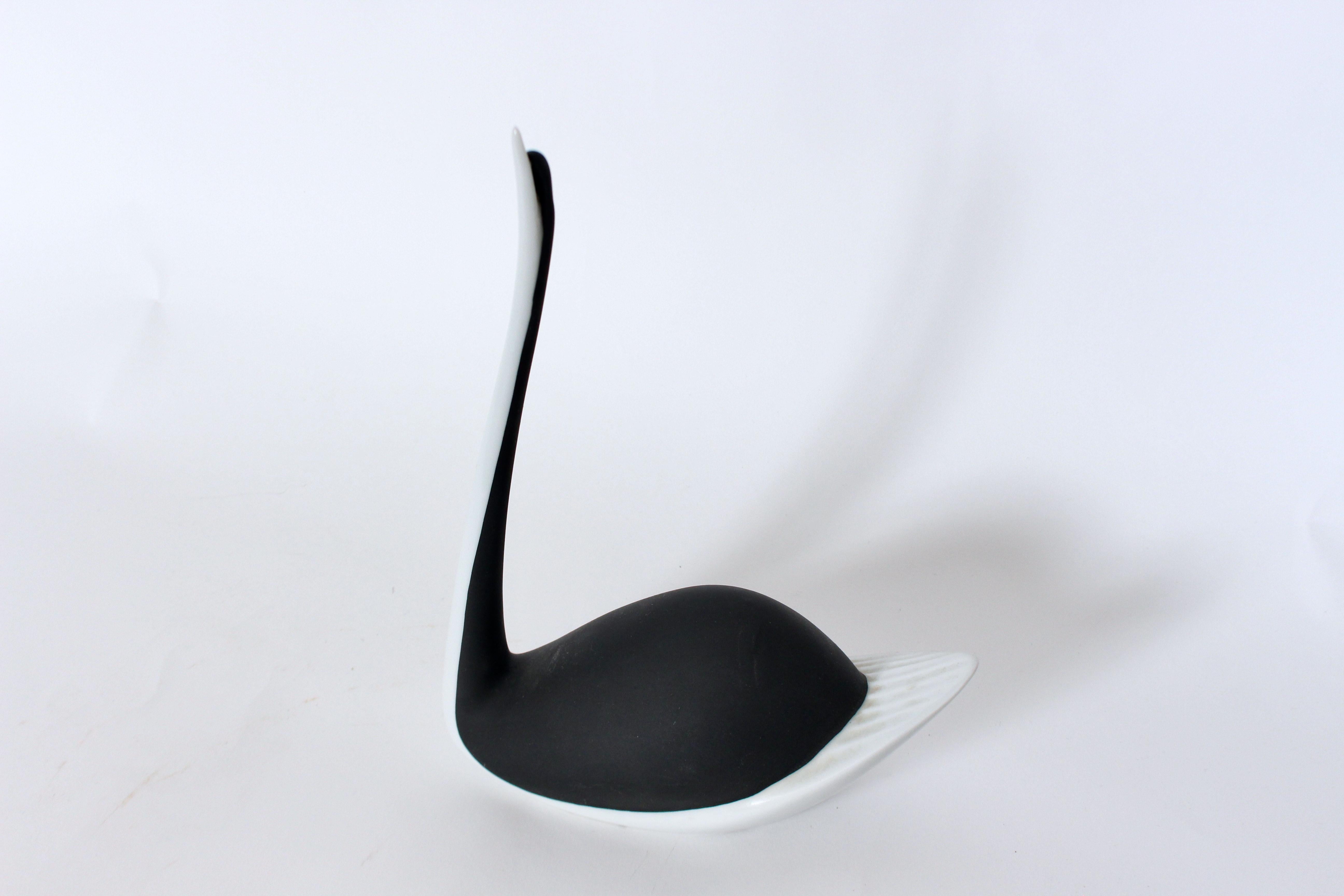 Jaroslav Jezek for Royal Dux Black & White Pottery Swan Table Sculpture. Featuring a handcrafted, hollow, curved, matte Black Pottery bodice, detailed with White gloss glazed accented, elongated neck and tail feathers. Small footprint. Original.