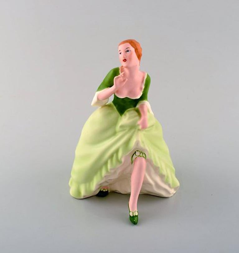 Royal Dux hand painted porcelain figurine. 
Woman in light green dress with skirt. Czech Republic, 1940s.
Measures 19.5 x 15 cm.
Stamped.
In perfect condition.