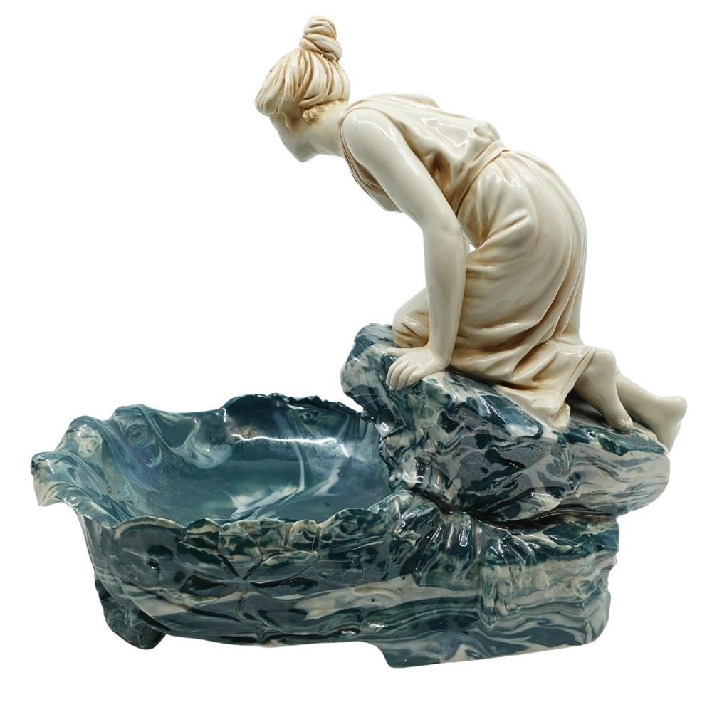 Offering this rare, marbleized jasperware pottery tray or vide-poche with iridescent glaze. This large figural tray features a cream-colored kneeling female figure gazing into a “pool” dish made from marbleized blue & cream pottery. This tray dates