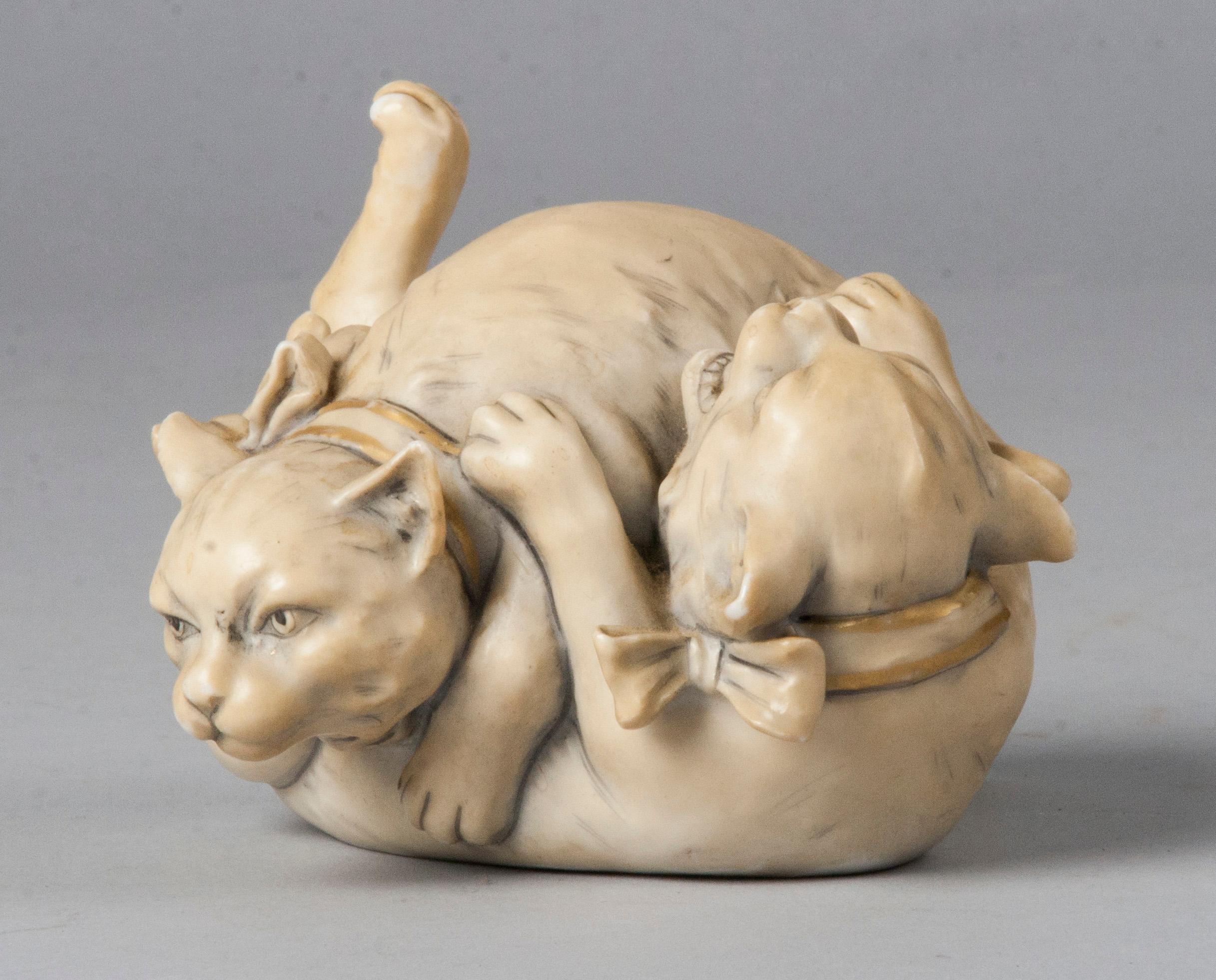 Cute small format statue made by Royal Dux, of two playing and rolling cats. The figurine has beautiful details, such as the expression of the cats and also the bows around their necks. An unusual subject for Royal Dux, because Royal Dux is best