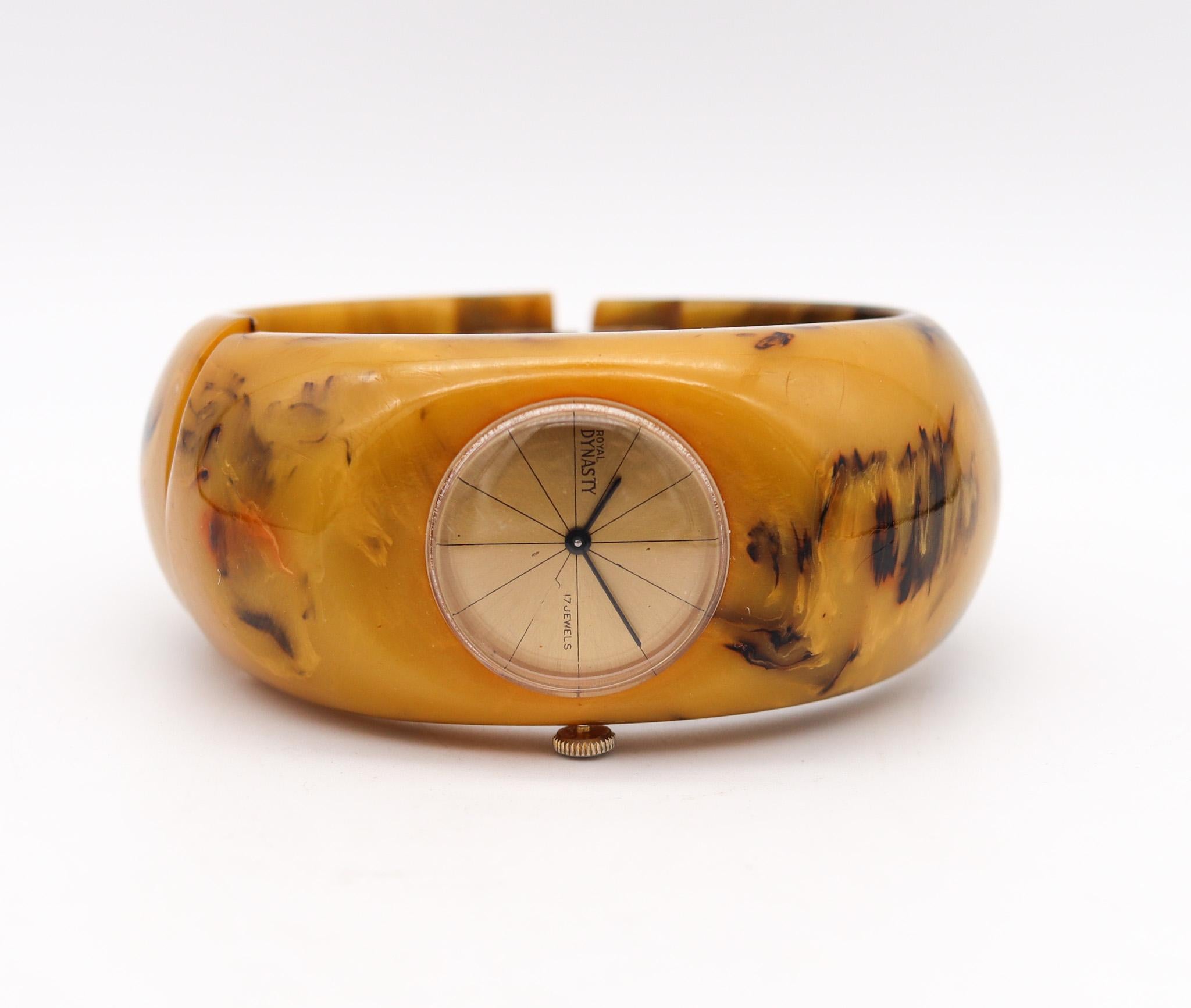 Butterscotch Bakelite Catalin Clamper Watch designed by Royal Dynasty.

A rare vintage genuine butterscotch Bakelite/Catalin clamper watch bracelet created by the Royal Dynasty Company. There is a hinge that allows the bracelet to open up and slip