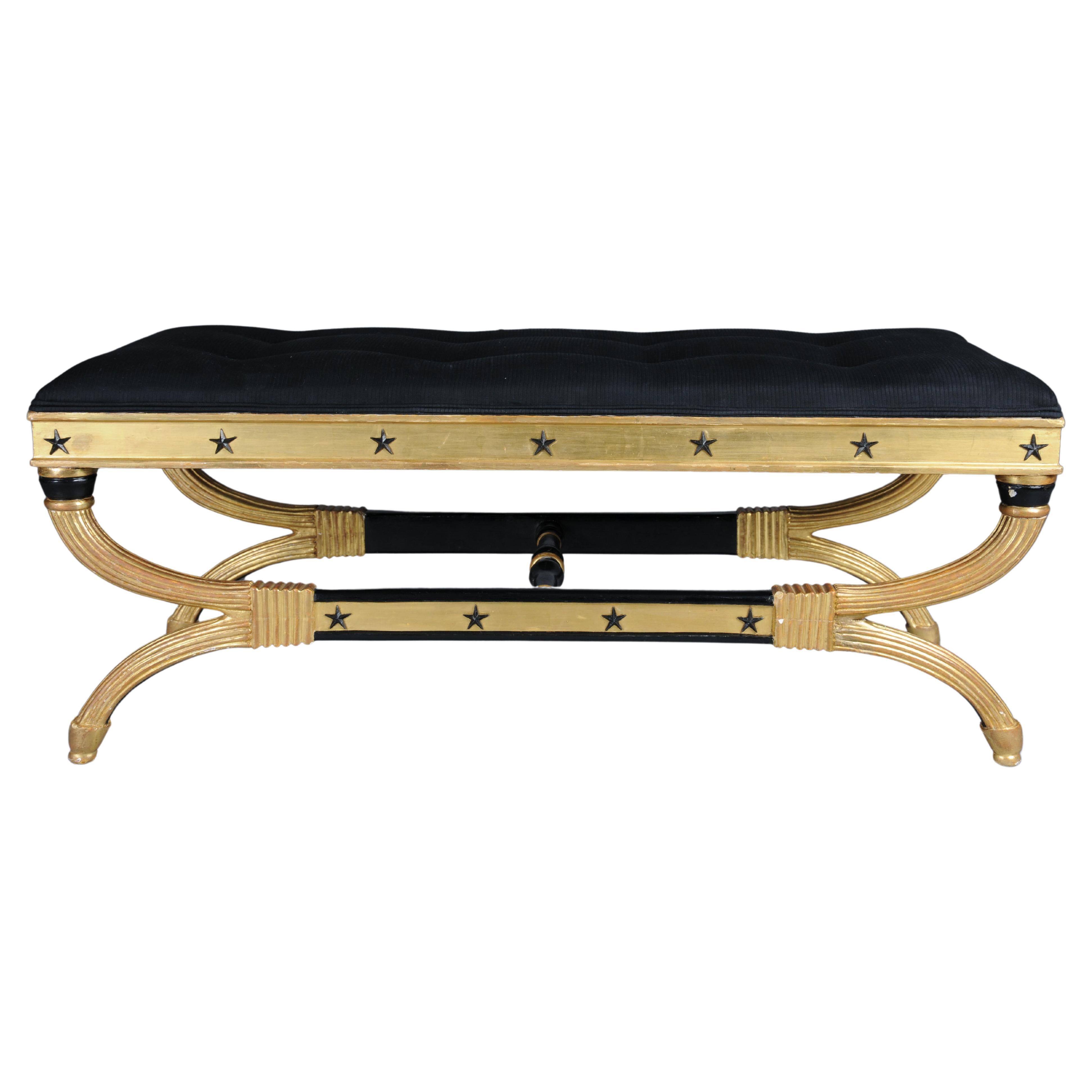 Royal Empire bench, gold-plated, black

Solid beech wood, gilded with black decorative elements.
Straight frame with black stars and base.
Curved base frame, partially grooved, connected to a central bar. Seat upholstery made from black high-quality