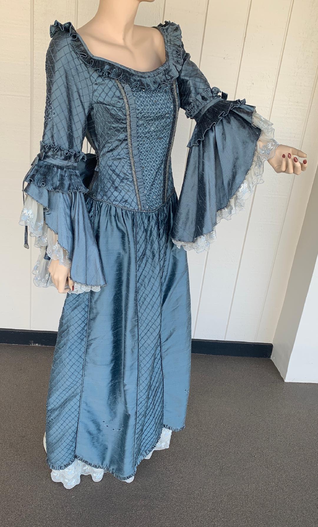 Fine quality, custom made, Marie Antoinette style ballroom evening gown or long dress is exquisitely made out of a rich blue gray colored raw silk or silk noil and has a somewhat rough texture (characteristic of this type of silk) and a graceful