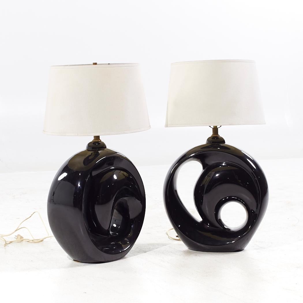 Royal Haeger Style Postmodern Black Swirl Pottery Lamps

Each lamp measures: 15 wide x 6 deep x 31 inches high

We take our photos in a controlled lighting studio to show as much detail as possible. We do not photoshop out blemishes. 

We keep you