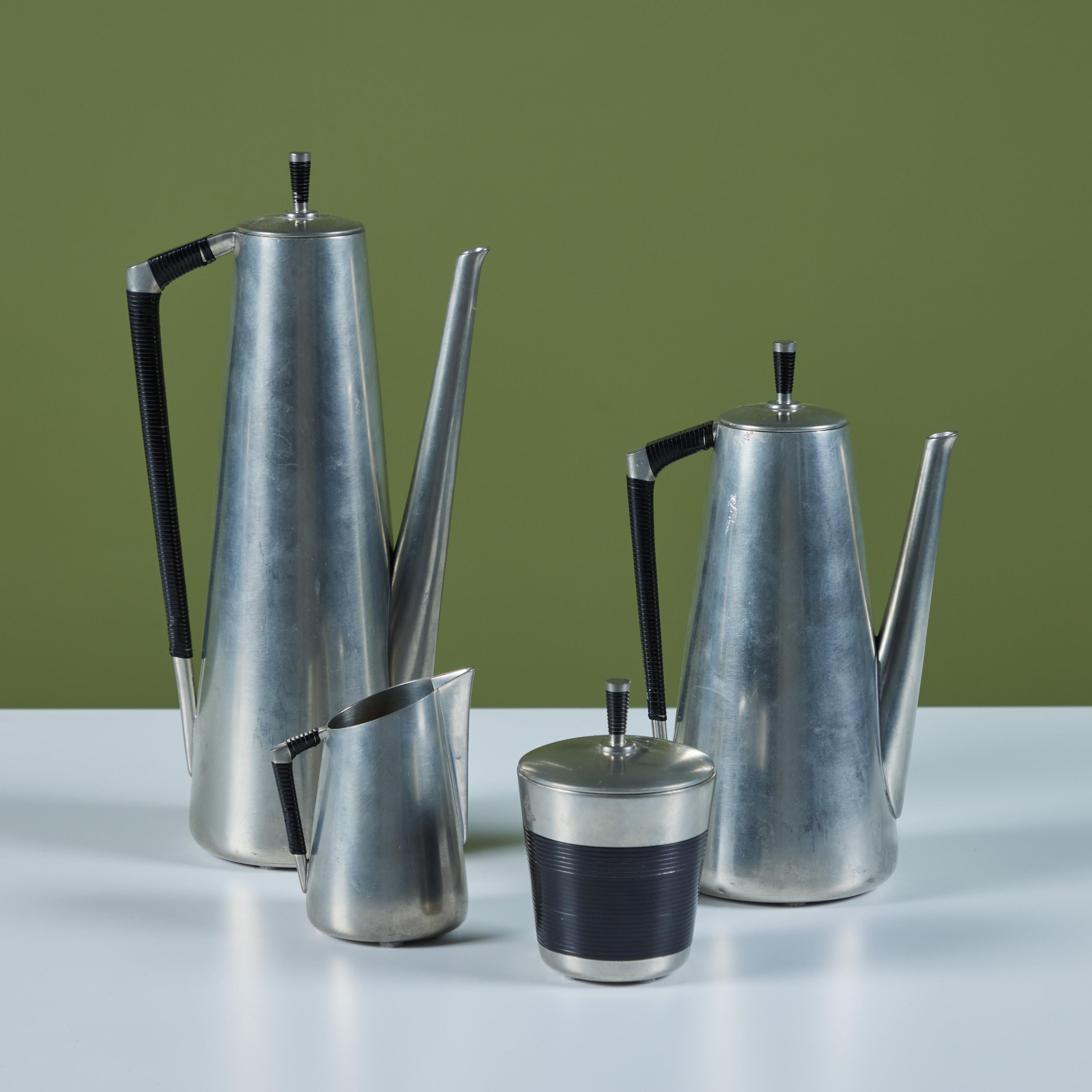 A Royal Holland four-piece service set in pewter with black vinyl accents, by J.N. Daalderop & Sons. This Royal Netherlands Metalworks set consists of two lidded pots used for coffee or tea, one creamer and one lidded sugar vessel.

Dimensions
Large