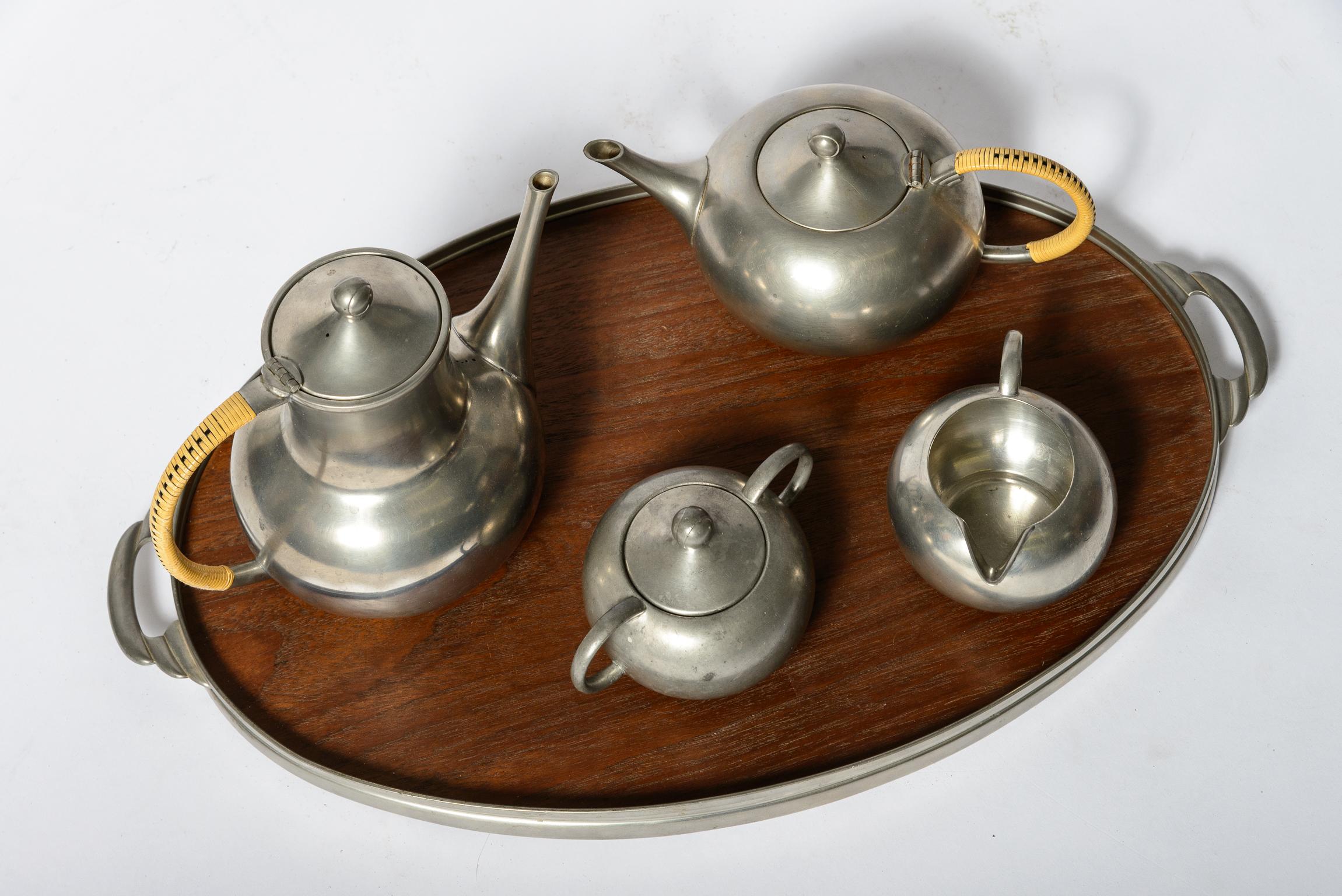 An original and complete Tea Set
Pewter, Cane and Walnut
Marked on underside