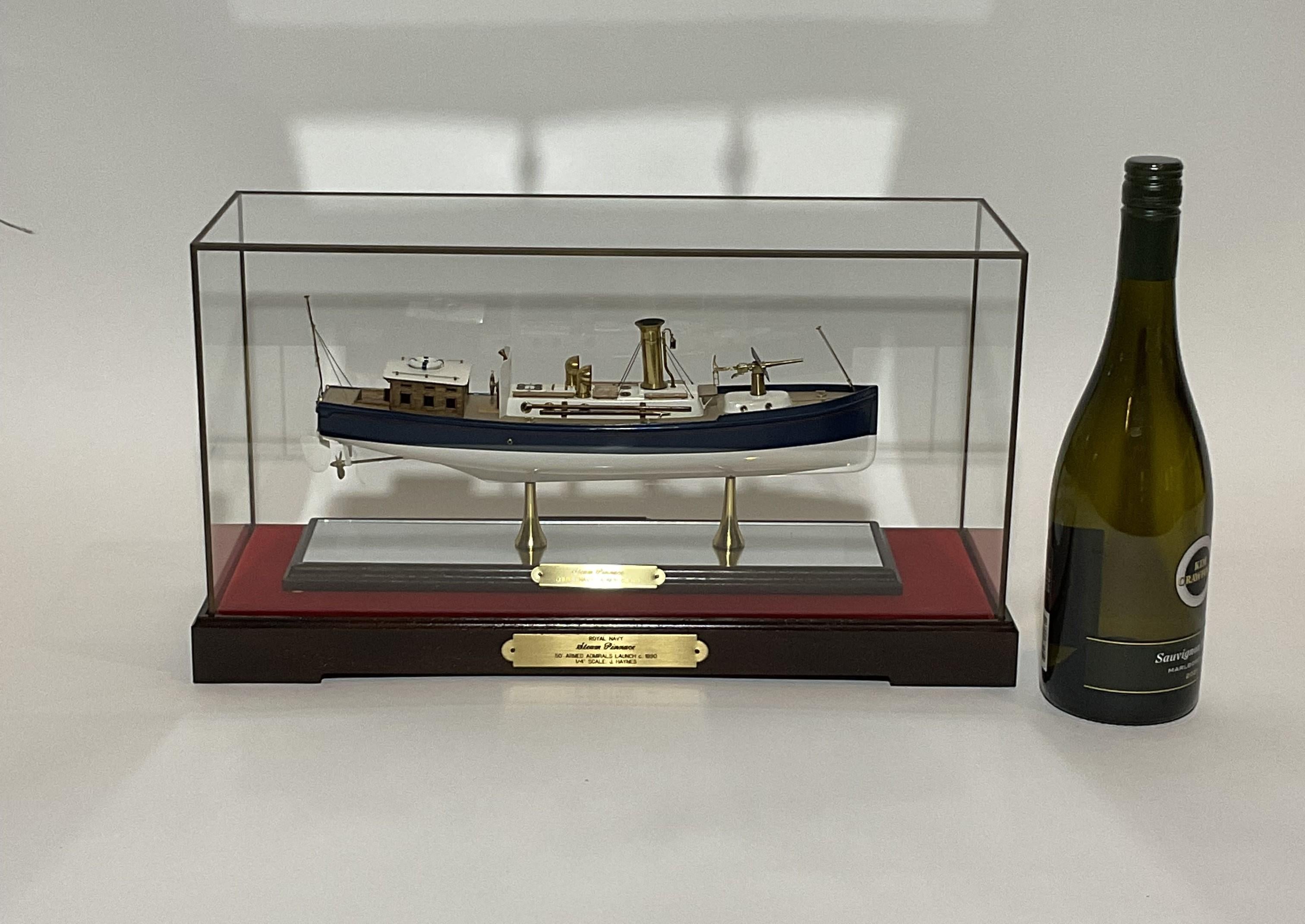 Fine scale model of a British Navy Admirals Launch by accomplished model maker John Haynes. Crisply detailed with basswood deck, brass fittings, cabin, deck gun, masts, lifering, ventilator cowls, etc.. Mounted on a mirrored base and felt lined