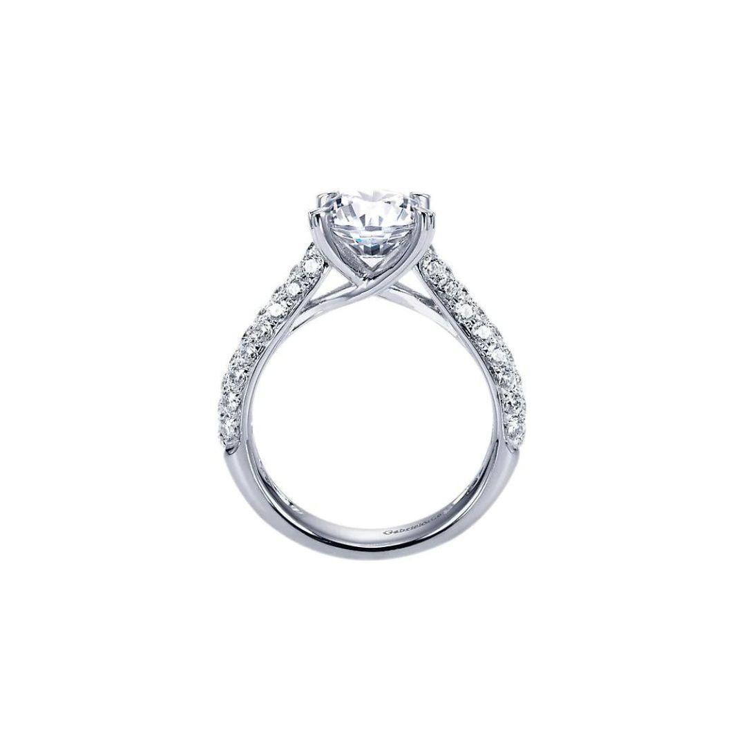 Royal Pave Fancy Tiffany Solitaire Design Diamond Engagement Mounting. Pave diamonds cover the sides, with an elegant undercarriage that wraps around the center stone. Center diamond NOT included. Ring fits up to a two carat stone in the center.
