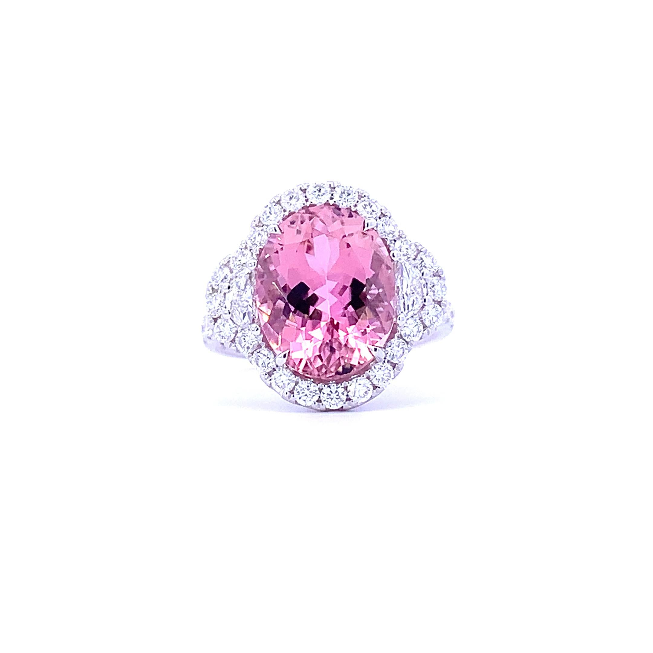 This Fancy Royal Pink Tourmaline Ring is a stunning piece of jewelry. Crafted in 18k white gold, it features a 6.04 carat oval pink tourmaline as the centerpiece, surrounded by 1.16 carats of diamonds and two half moon diamonds. The perfect choice