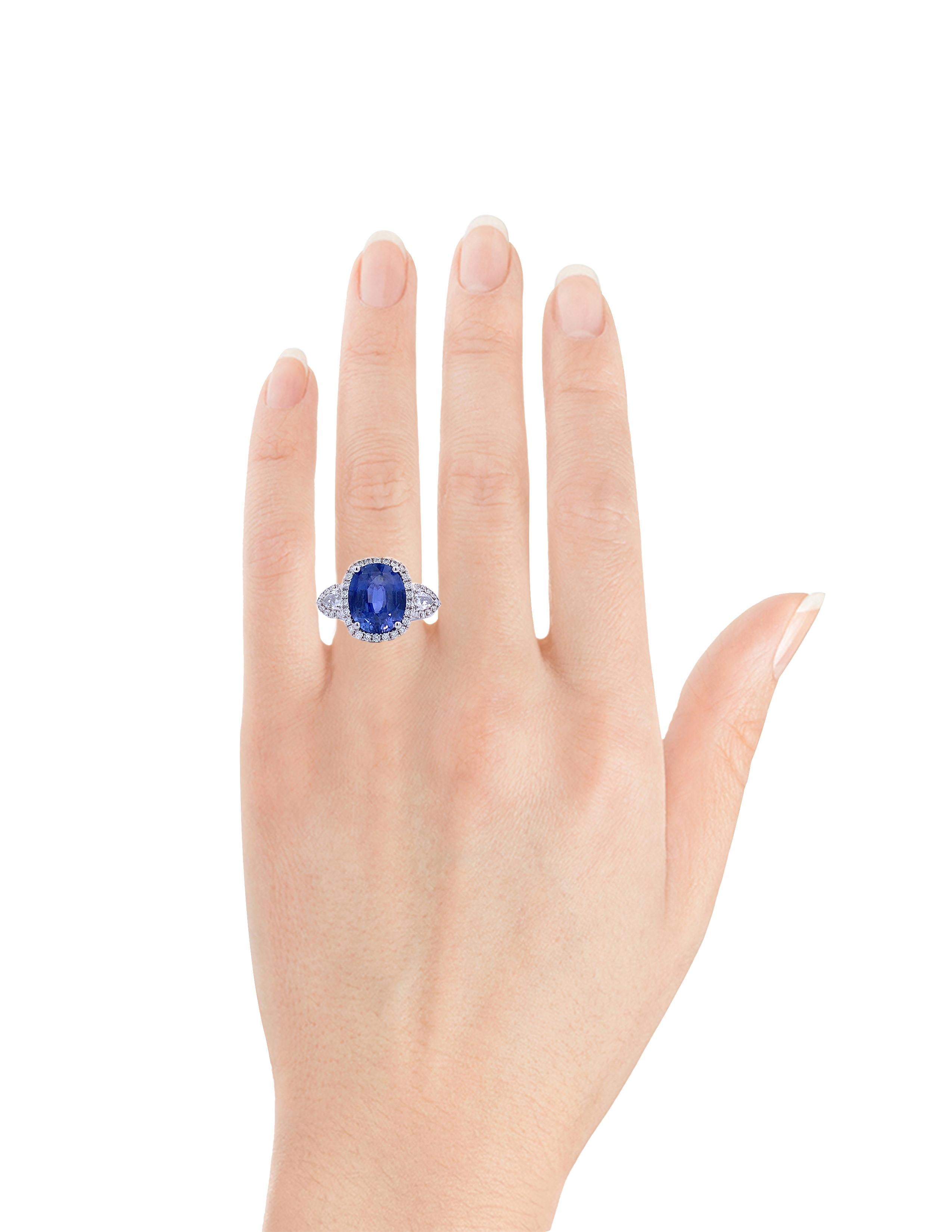 This Fancy Sapphire Ring (#17477) is the perfect choice for any special occasion! It features a stunning 5.55 carat sapphire, surrounded by 0.88 carats of dazzling diamonds set in 18k white gold. This ring is GIA certified, ensuring that the highest