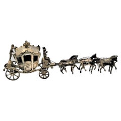Royal silver coach in 18th century style pulled by four horses