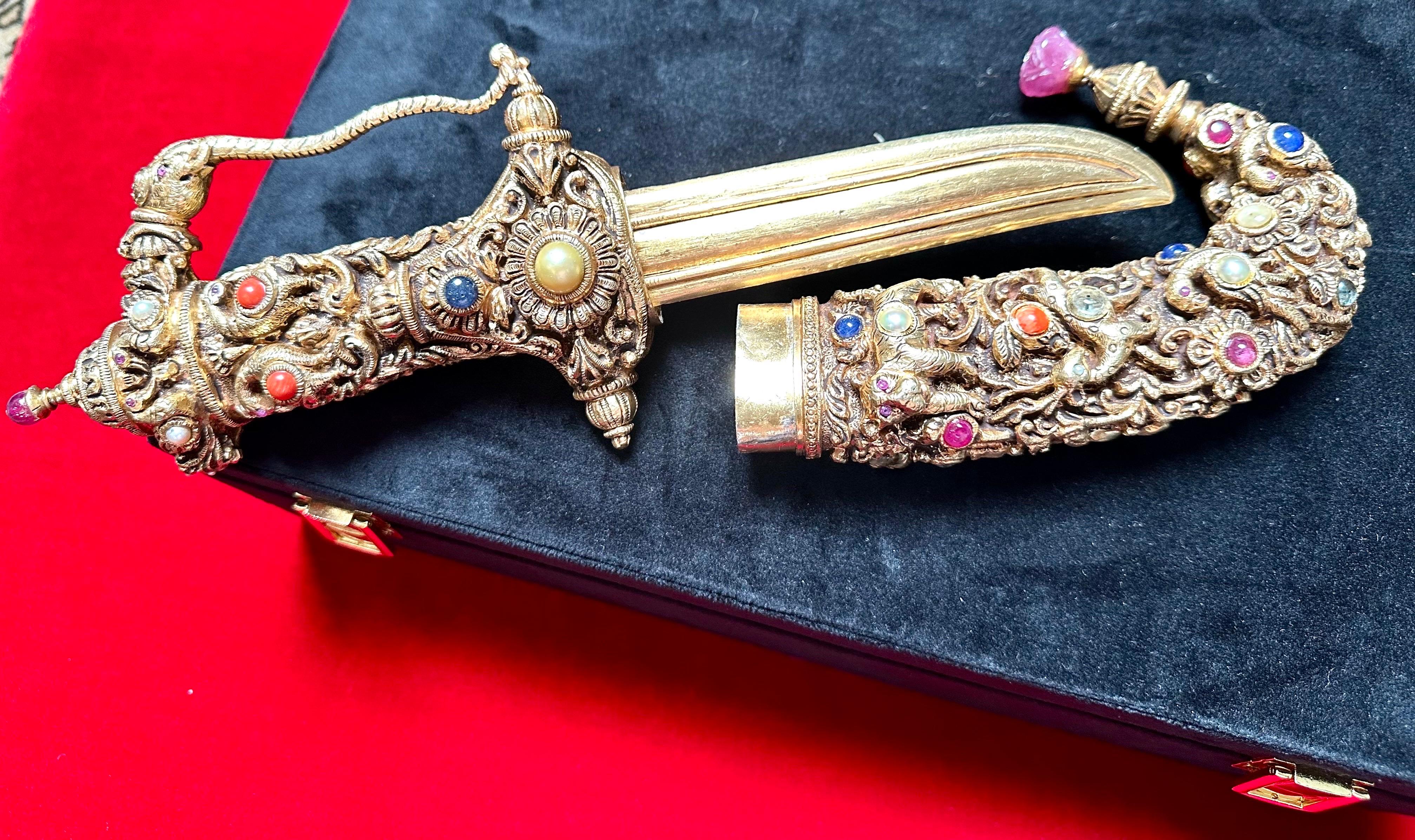 Introducing the captivating Silver-Gilt & Jewel Mounted Dagger, a true masterpiece of craftsmanship. This Mughal-inspired dagger knife, made from 1.1 kg of silver, serves as an exquisite collectible to adorn your living room. Its regal design