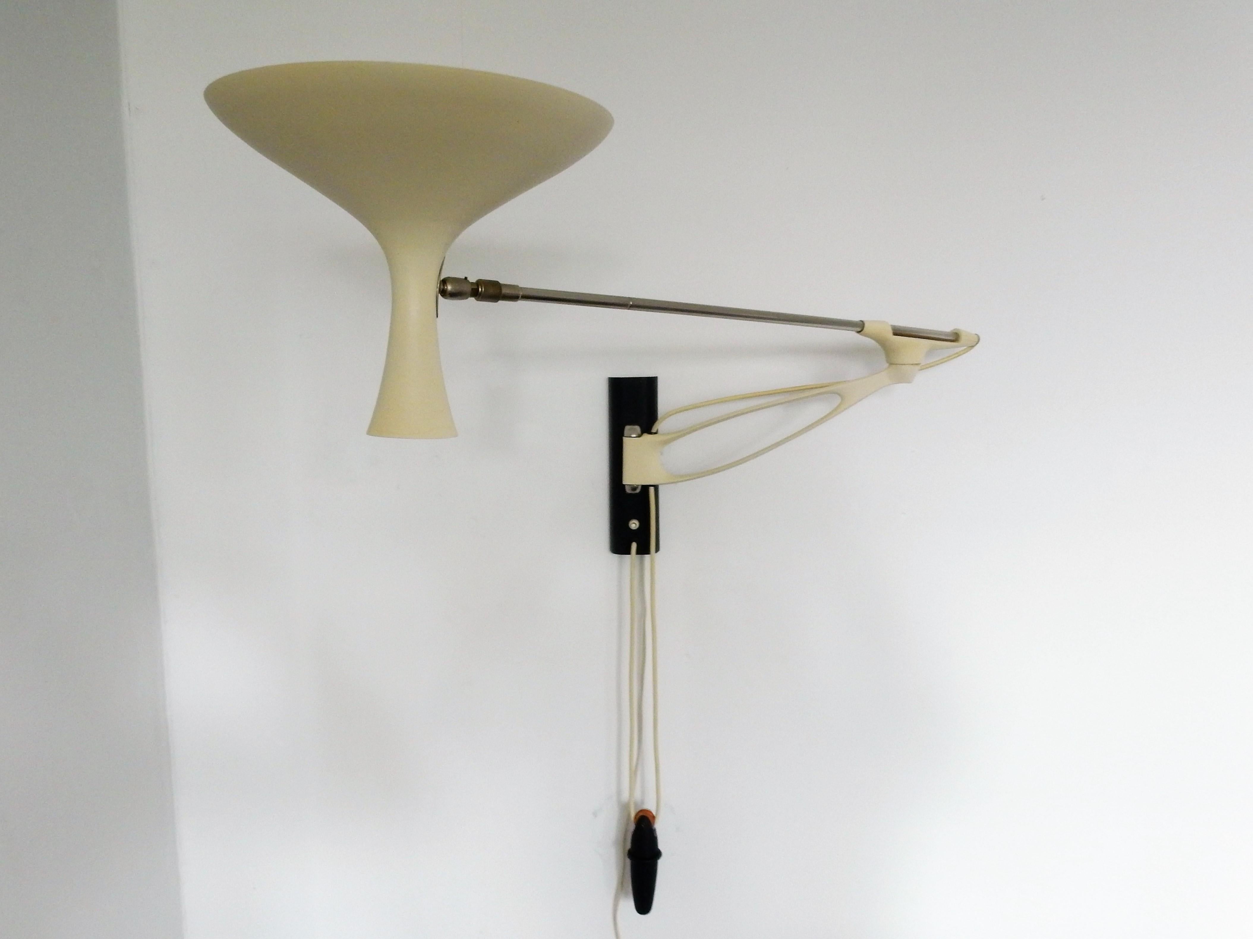 This stunning and quite rare adjustable wall lamp, model 'Royal', was designed for Gebrüder Cosack in Germany in the 1950s. The diabolo shade is white enameled in a 'shrink finish', mounted on a telescoping arm. The lamp can be pulled out from 100cm