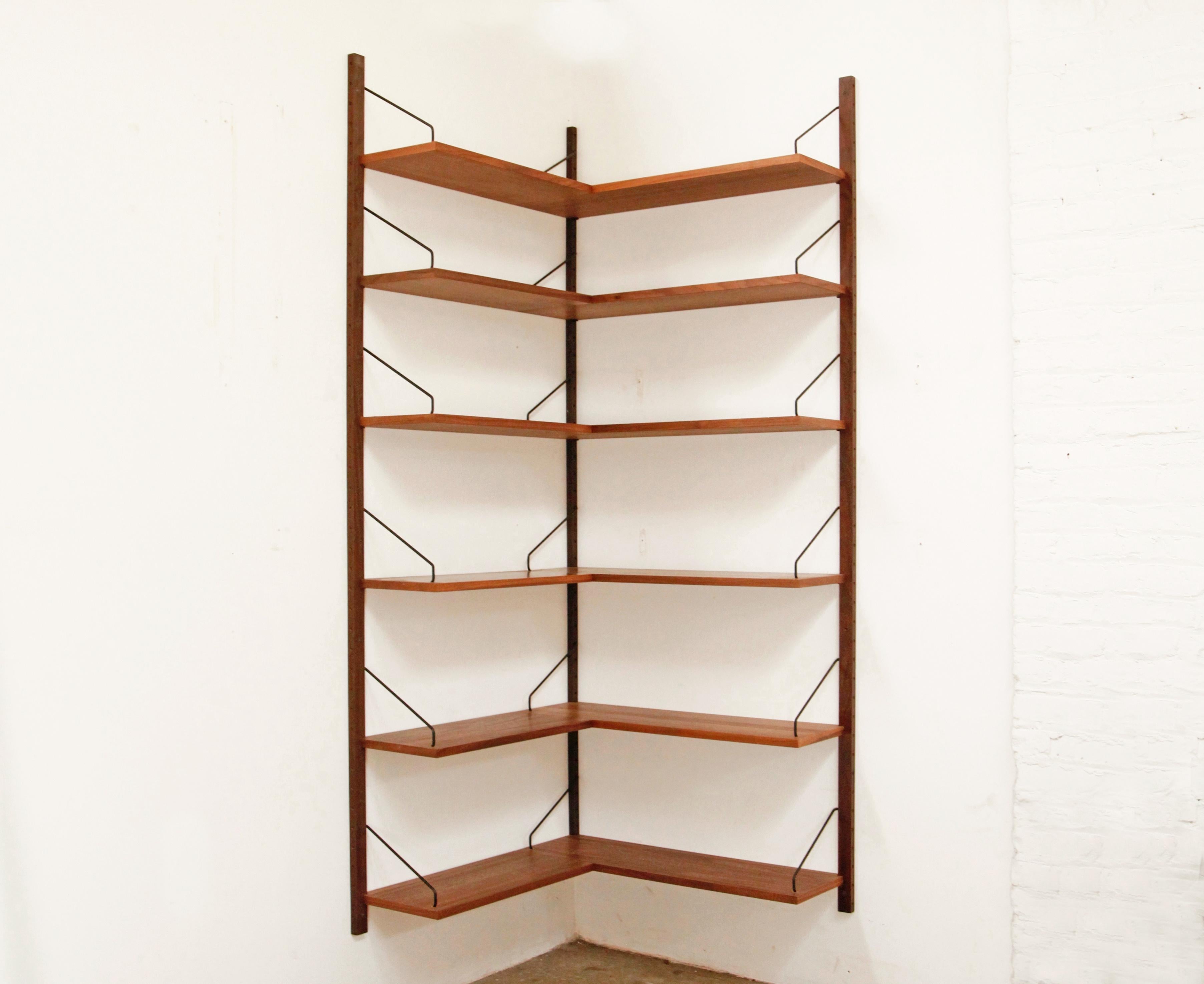 Rare deadstock Royal System corner bookshelf in walnut by Poul Cadovius. These shelves were taken out of their original boxes to be installed for this photo only. It has been deinstalled and put back in it's original boxes. Perfect deadstock