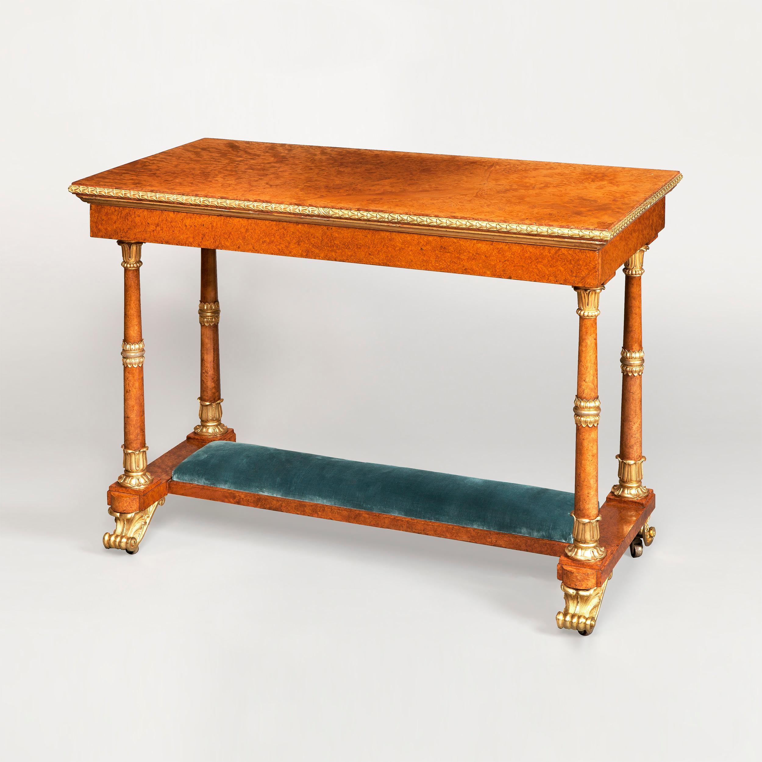 A highly important and rare royal table made by Morel & Seddon for the Windsor Castle Commission, commanded by George IV 

Constructed in Amboyna, with ormolu gilt bronze mounts, having highlights in parcel-gilt; rising from ormolu scroll feet cast