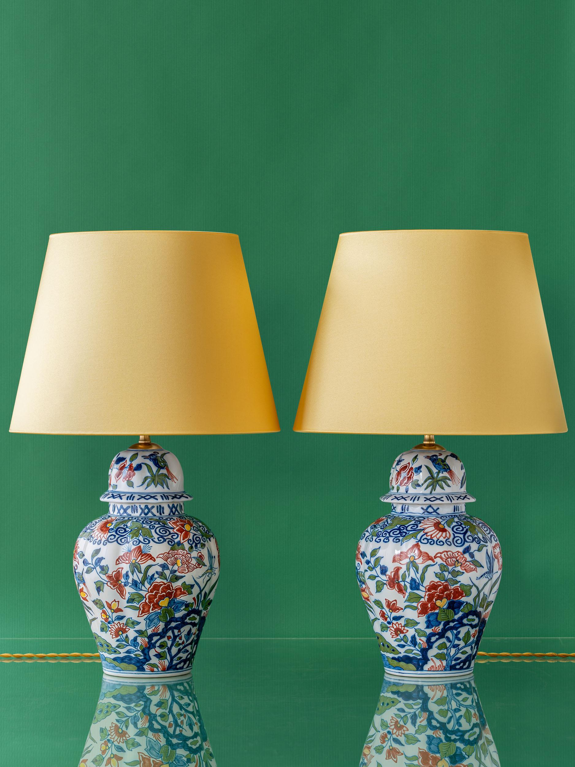 A one-of-a-kind pair of lamps, Kie & Vit  have been lovingly handcrafted from gorgeous, vintage, hand-painted vases in a Delft style by Royal Tichelaar Makkum, the oldest ceramic company in the Netherlands, established circa 1572. Kie & Vit are