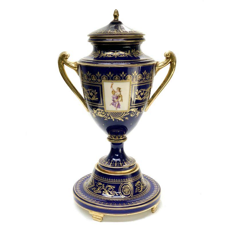 Royal Vienna Austria Hand Painted Porcelain Twin Handled Urn, Othello, circa 1900.

A cobalt blue ground with gilt foliate scroll accents. The central area depicts a hand painted scene from Shakespeare's Othello. Royal Vienna beehive mark to the